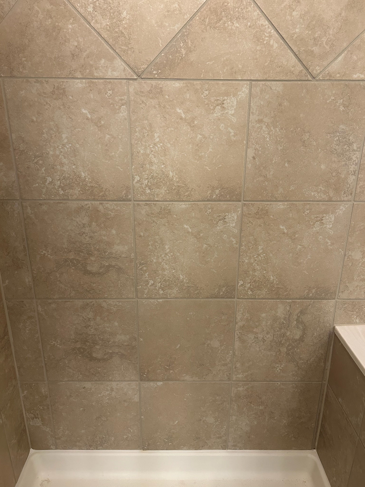 Same bathtub wall with fresh clean grout lines