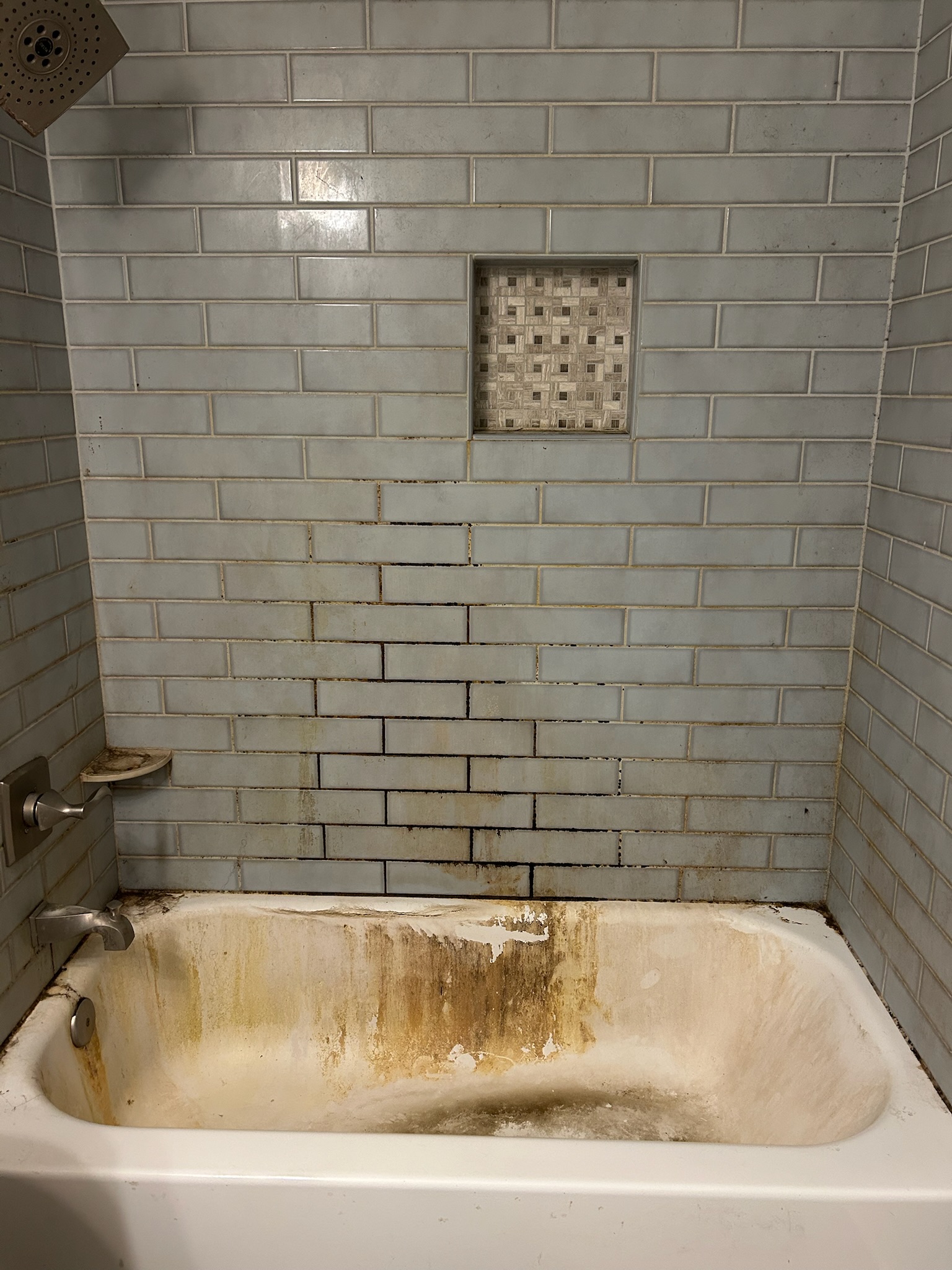 Before: Shower with severe tile and grout damage