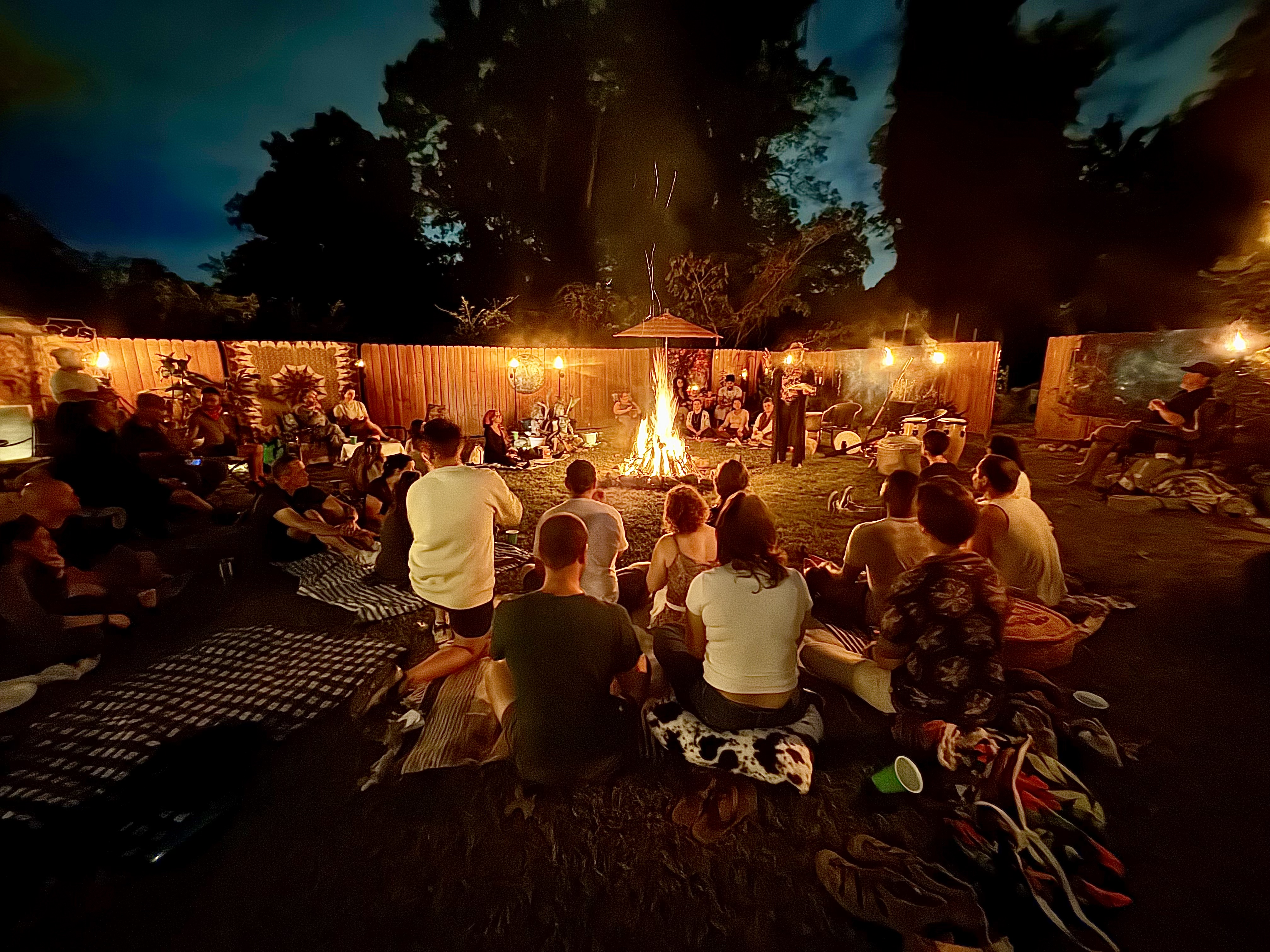 Community around bonfire at night