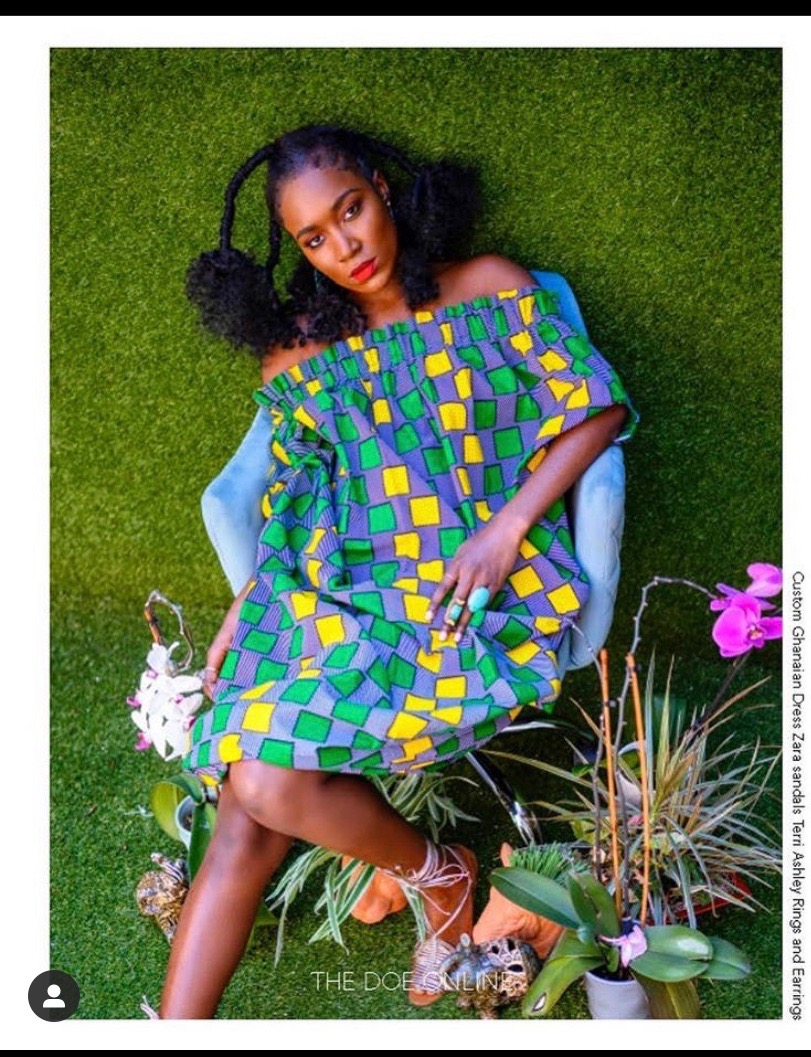 Vibrant patterned outfit with colorful makeup in a garden setting