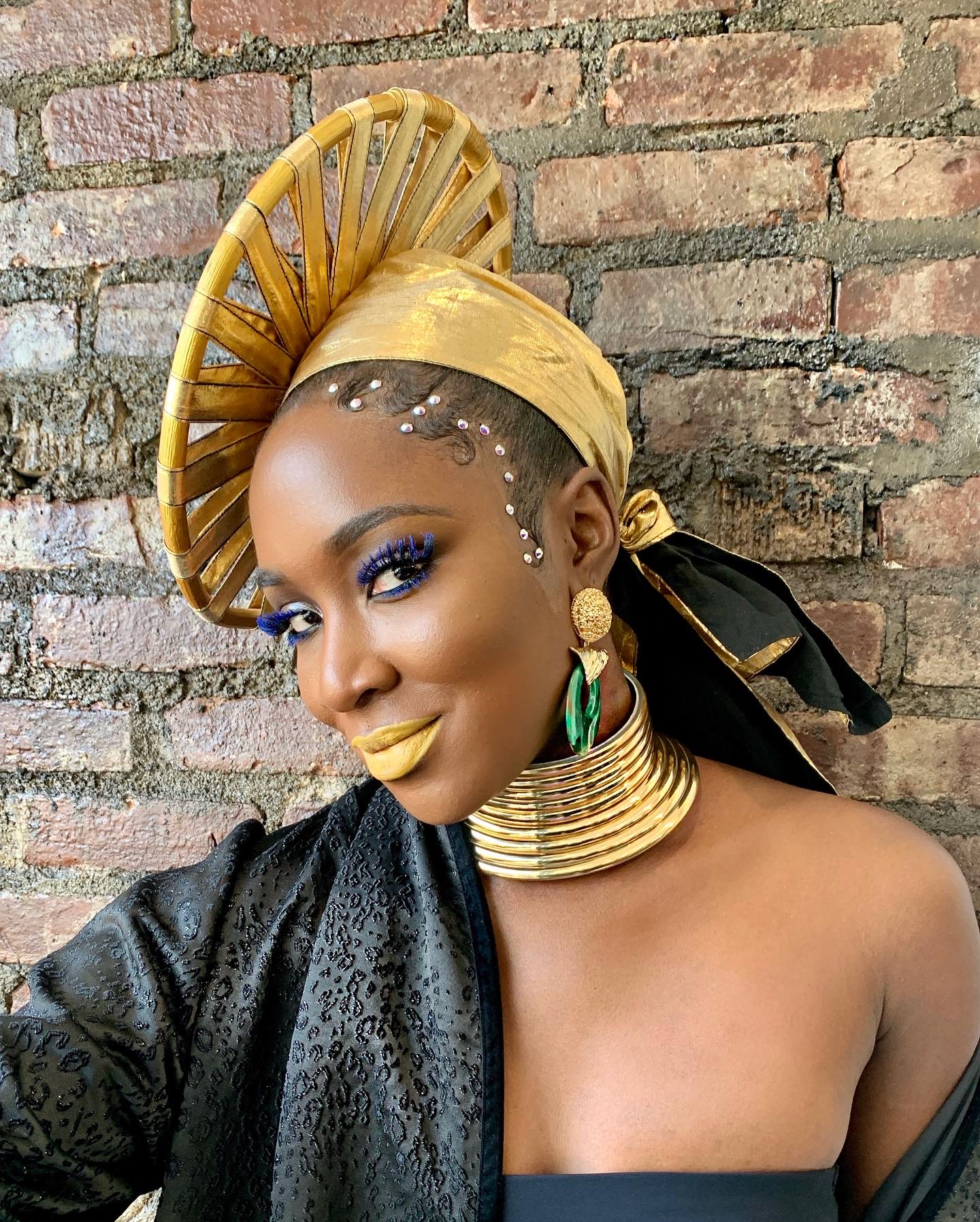 Gold headwrap and jewelry with golden eye makeup
