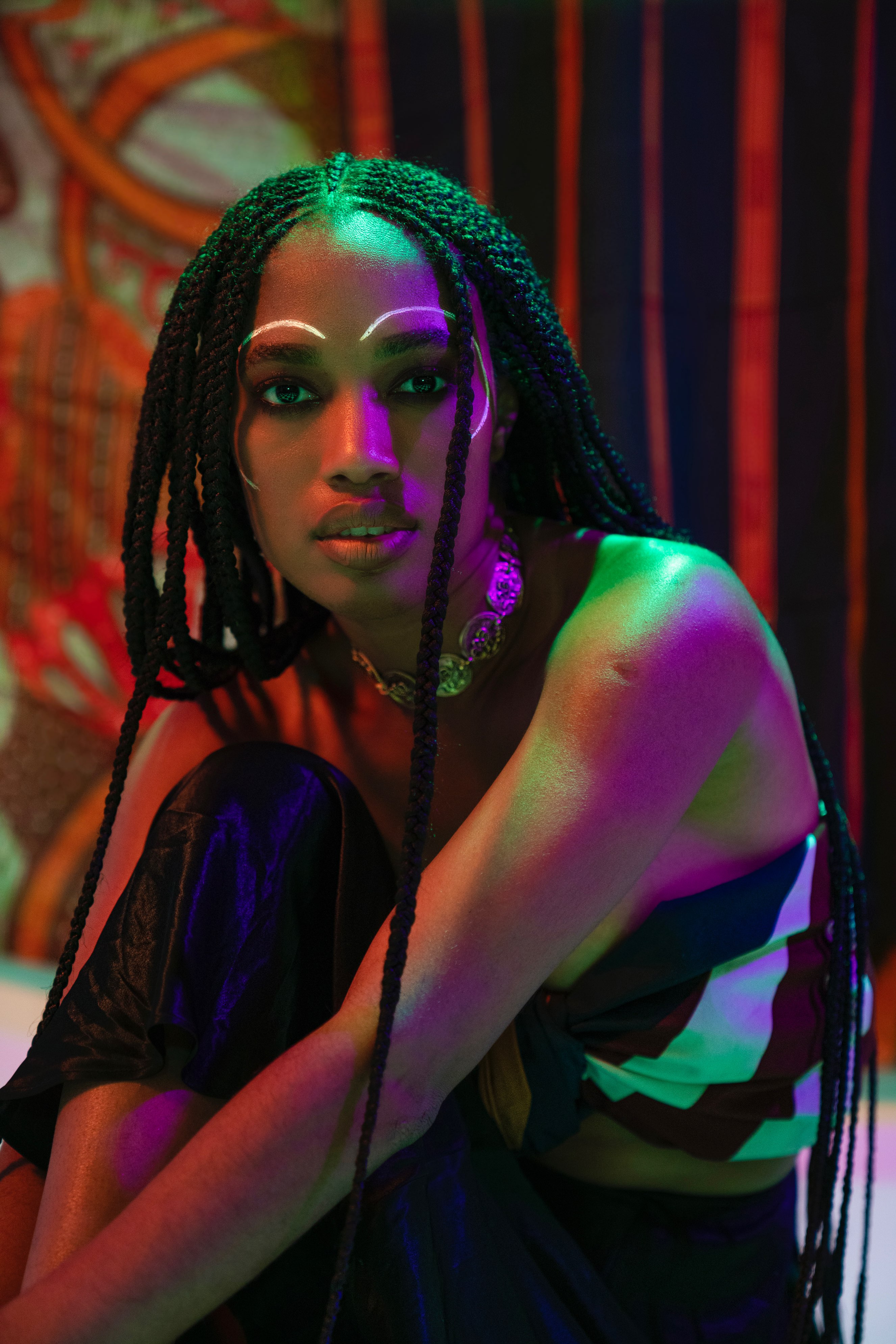 Beauty portrait with green and purple lighting and dramatic eyes