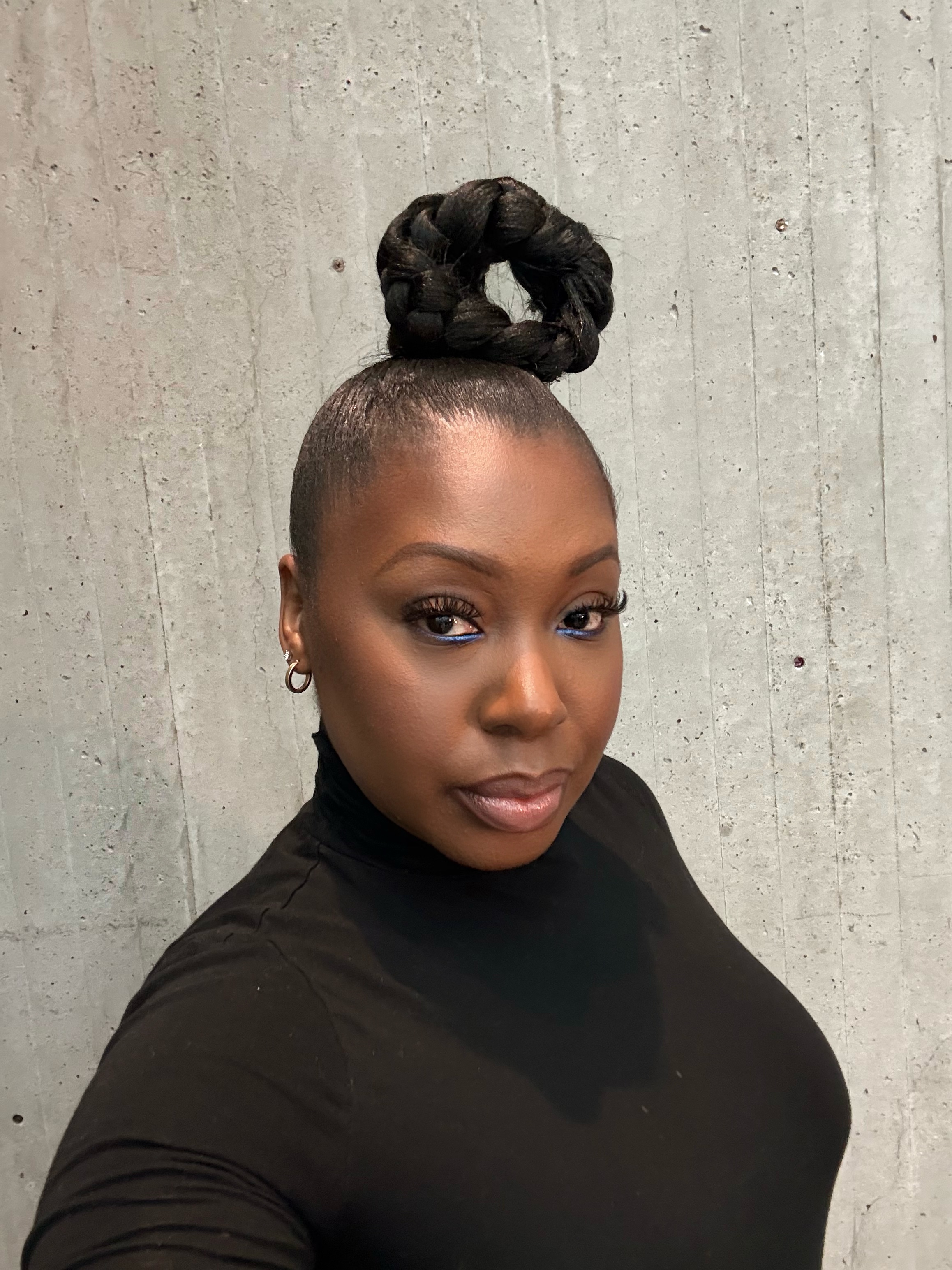 Makeup artist Avida Thompson in a black top