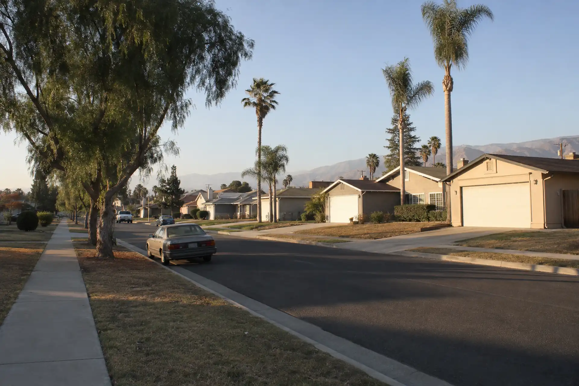 1970s single-story tract homes on a residential street in Riverside, CA