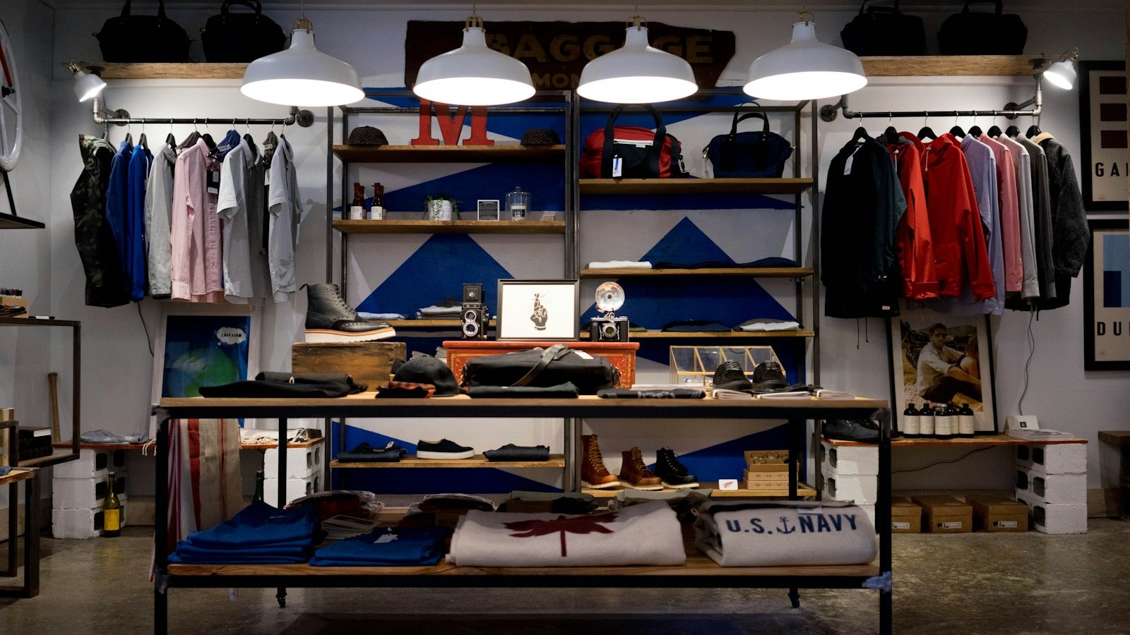 Lived-in boutique stock display with apparel racks, shelving, and product tables — clear inventory, not pretty seasonal fluff. Lived-in boutique stock display with apparel racks, shelving, and product tables — clear inventory, not pretty seasonal fluff.