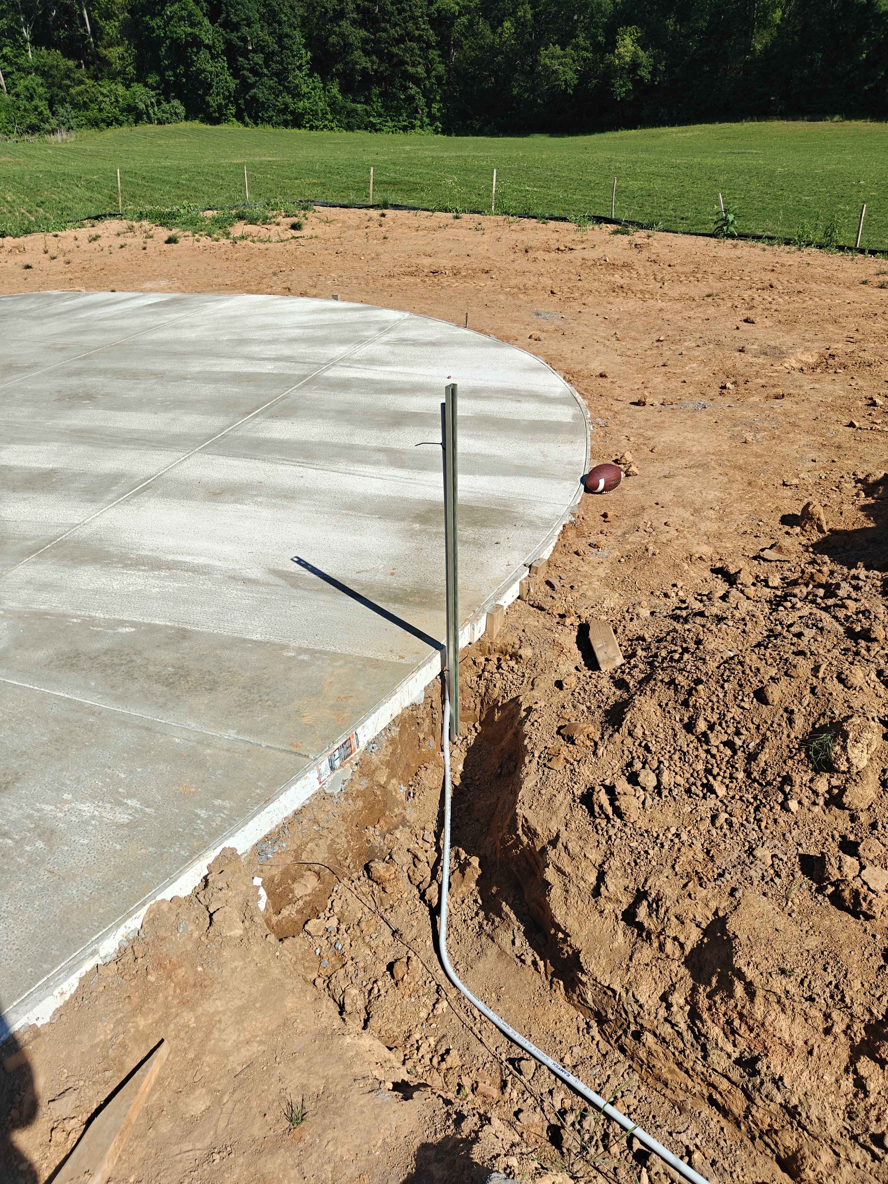 Conduit stubbed up at the edge of the new pool deck, run from the trench for the underwater pool lights