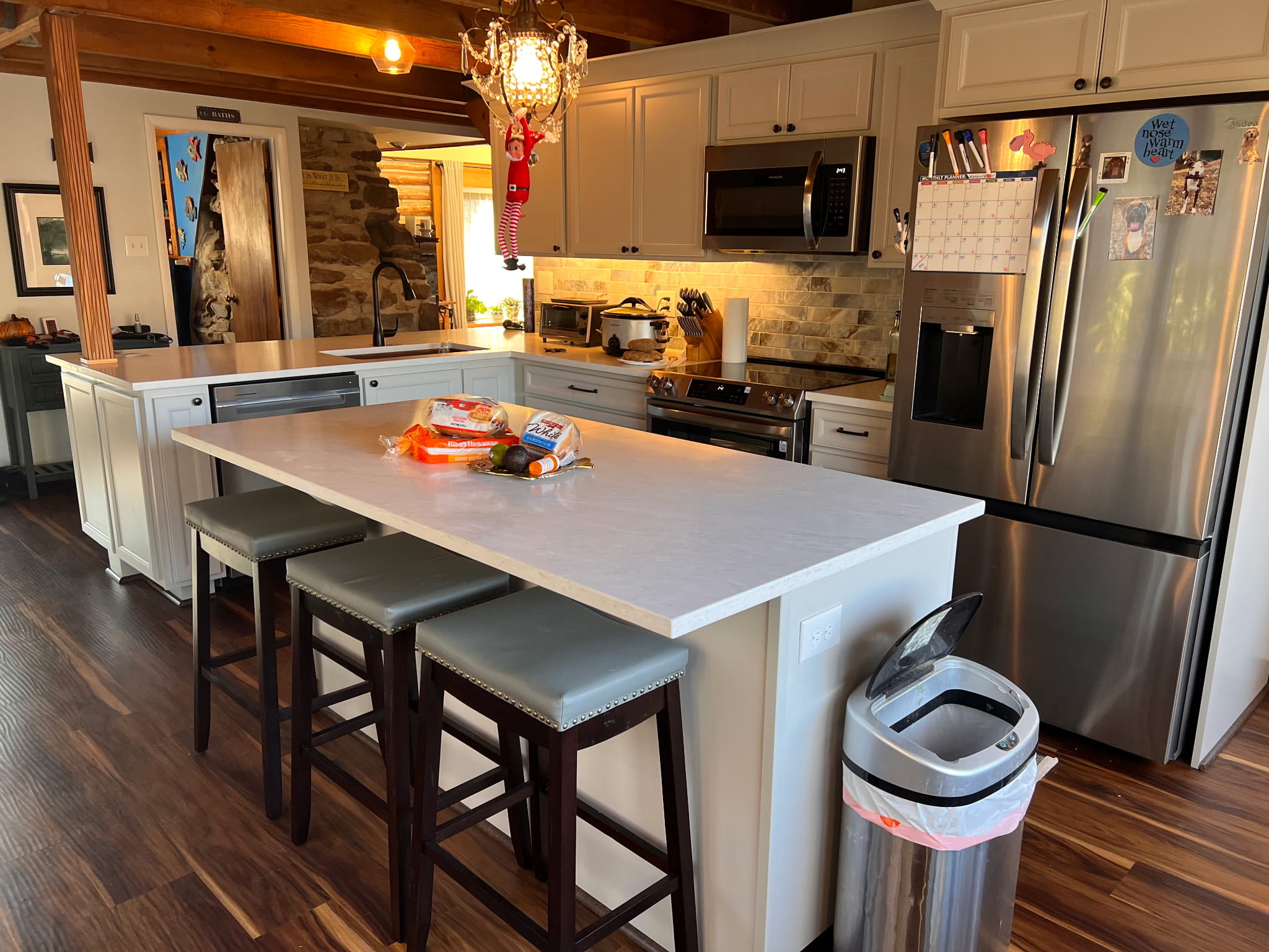 Modernized kitchen in Prince William County with a large island and original timber beams