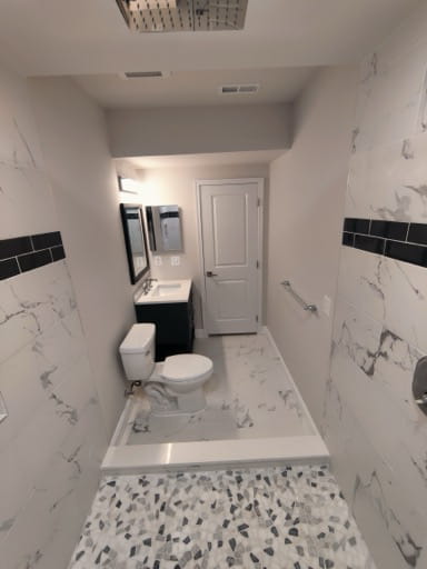 New basement full bathroom with marble-look tile and a walk-in shower