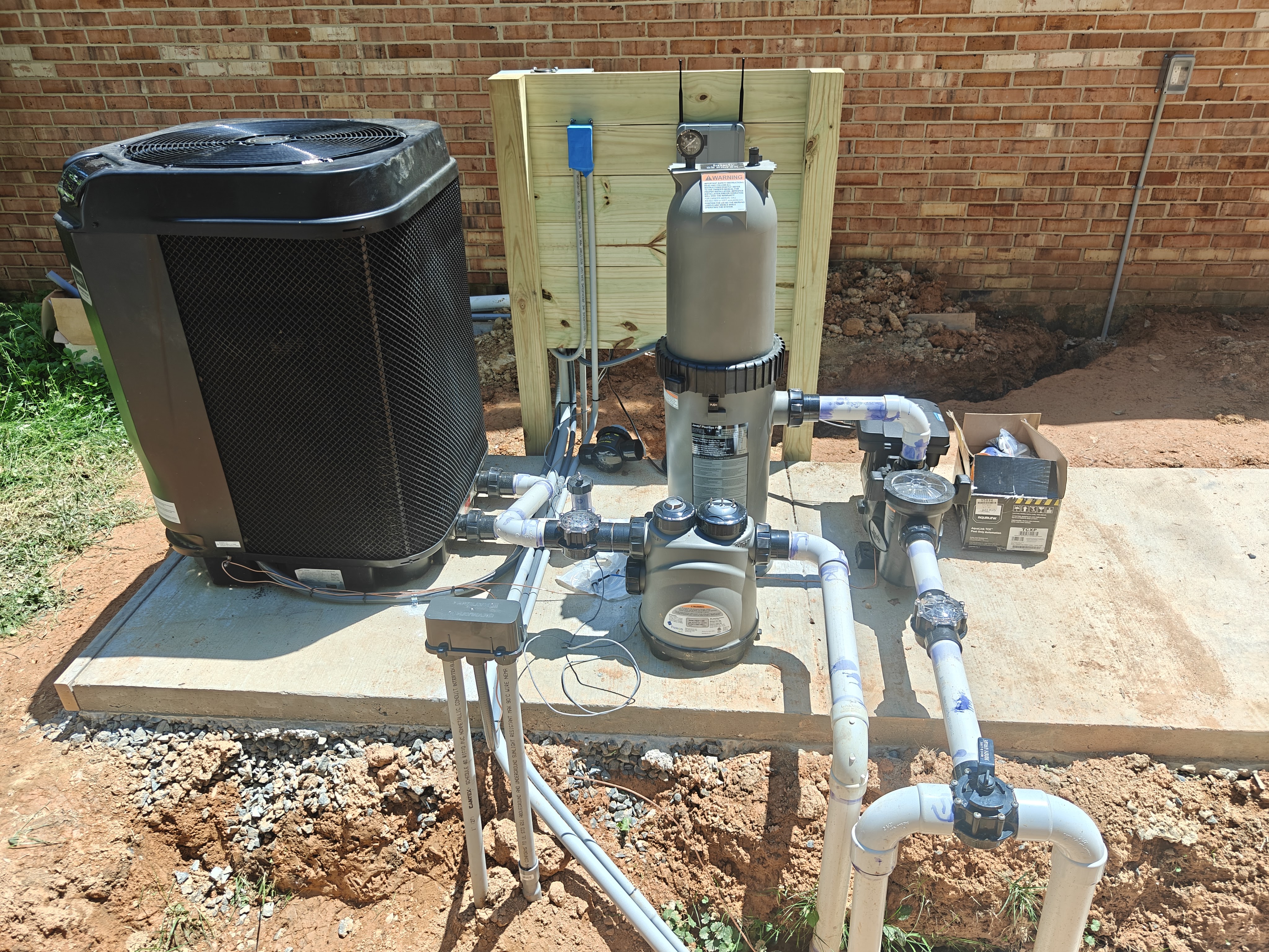 Pool equipment pad in Manassas with heat pump, filter, pump, and custom rack