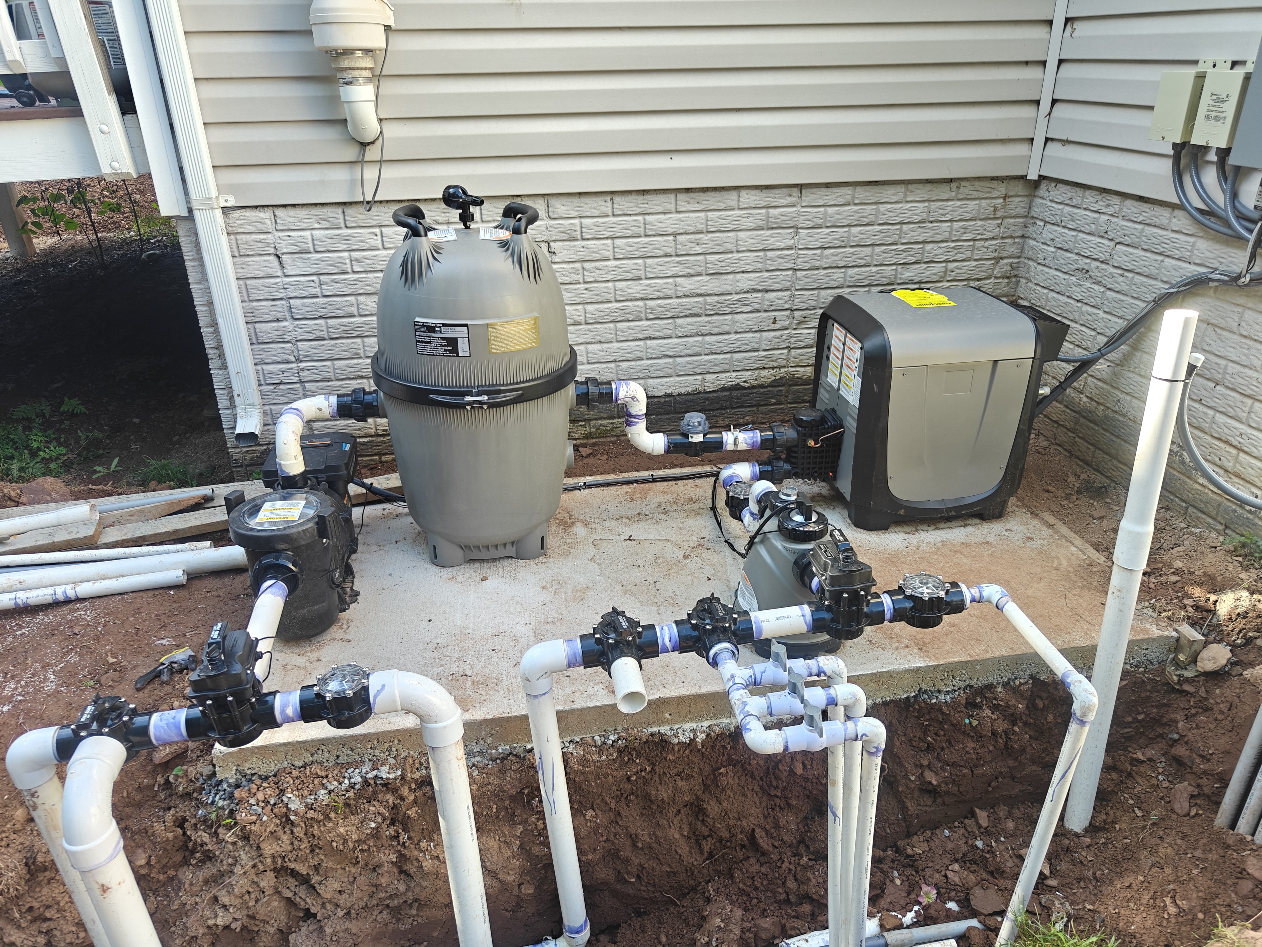 Pool equipment pad in Bristow with filter, pump, heater, and Jandy valves