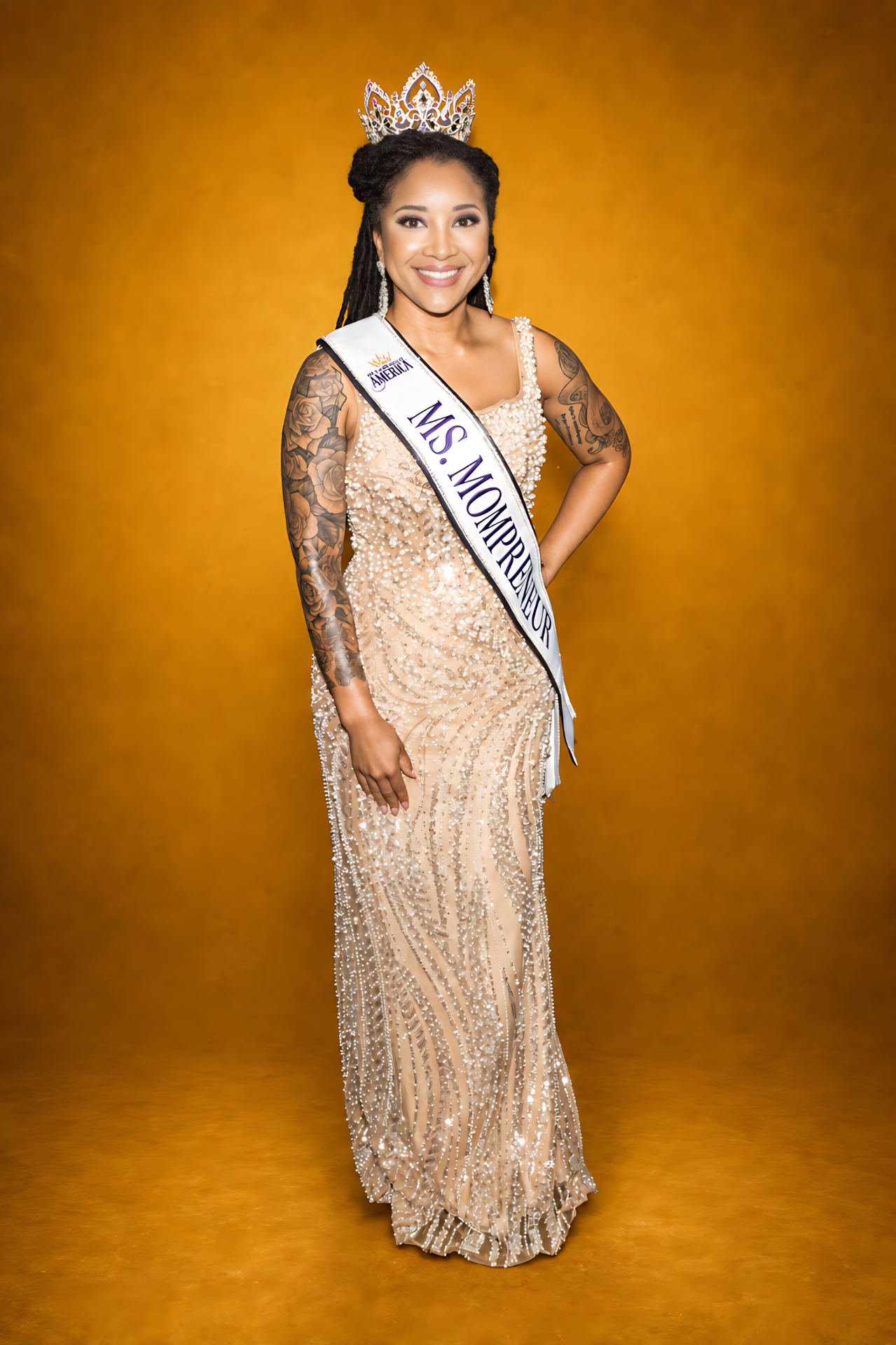 Ms. Mompreneur titleholder in crown and sash