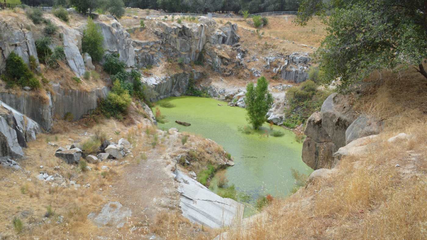 The flooded California Granite Company quarry with granite walls on Pacific Street, Rocklin