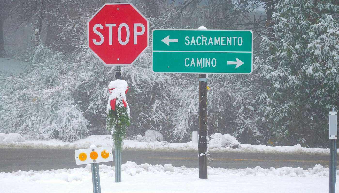 A snowy Carson Road sign pointing to Camino
