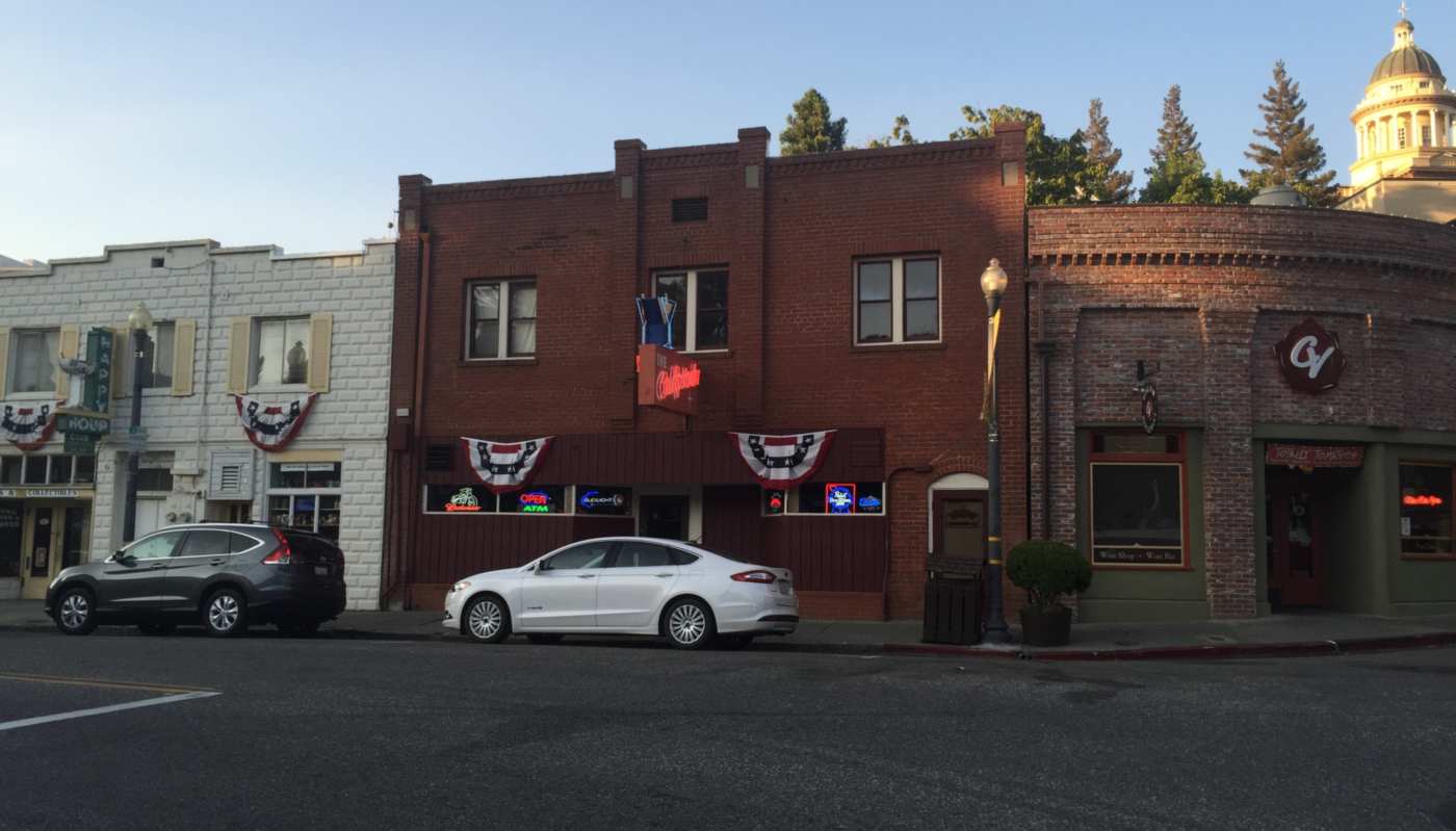 Brick storefronts with flag bunting in Old Town Auburn