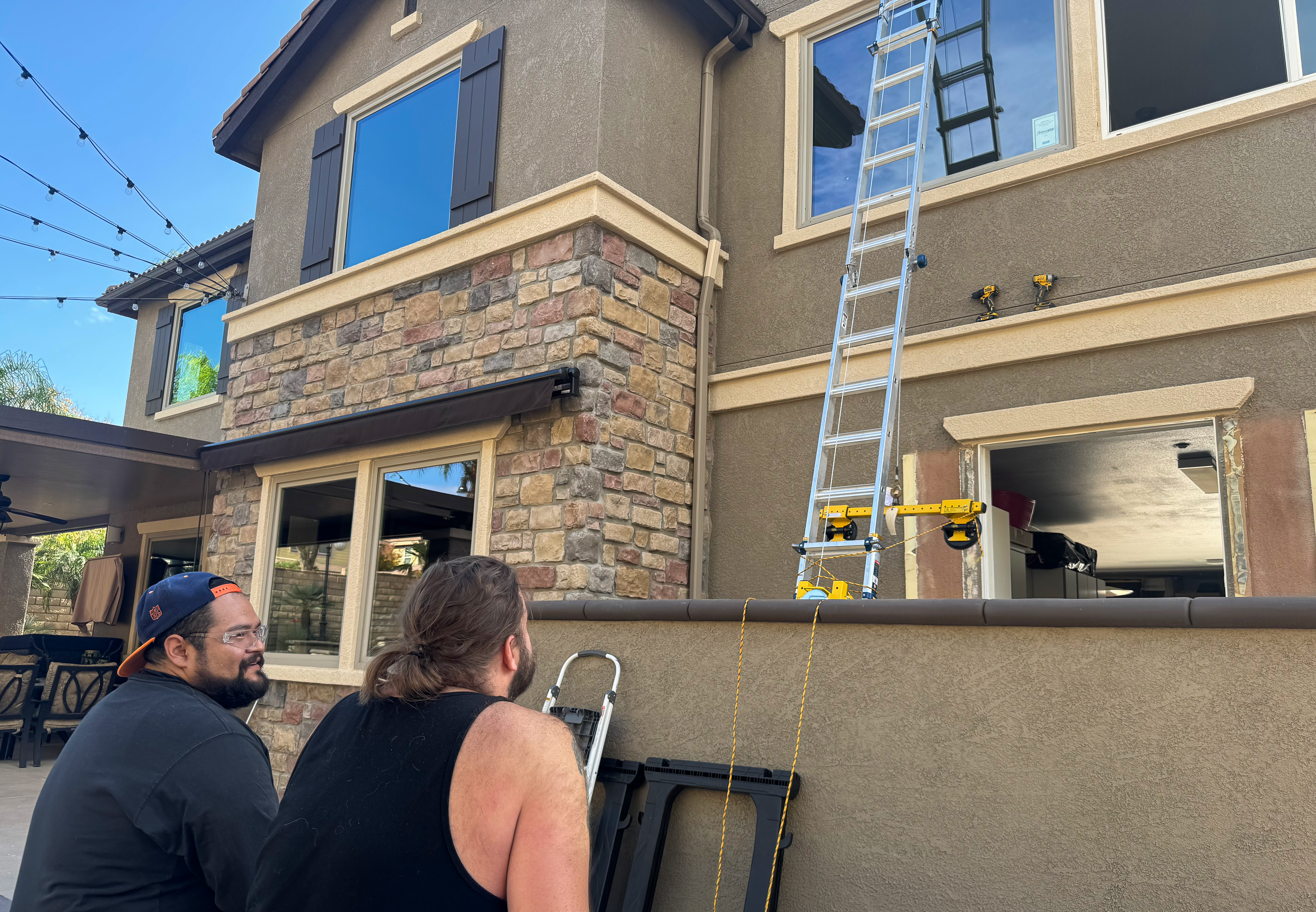 Legion crew installing a second-story window from a lift