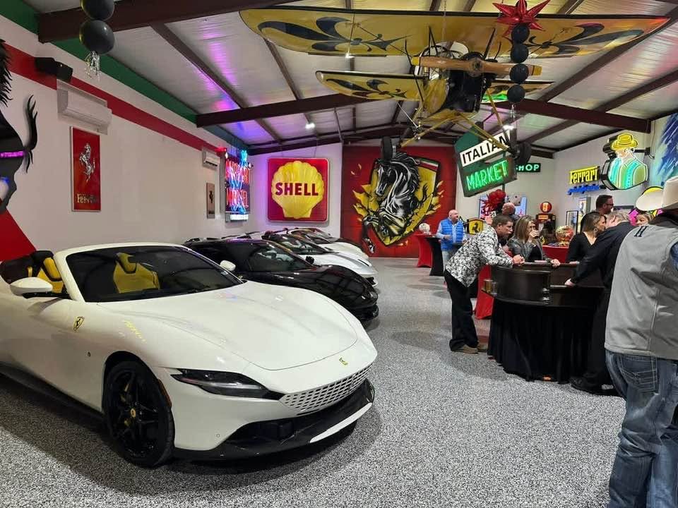 Ferrari Room private event space with vintage car display and guests.