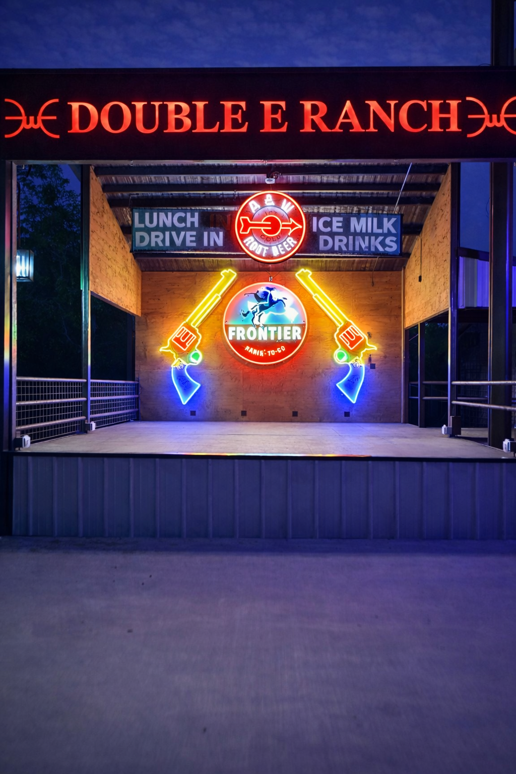 Double E Ranch & Venue illuminated sign with drive-in restaurant and bar details.