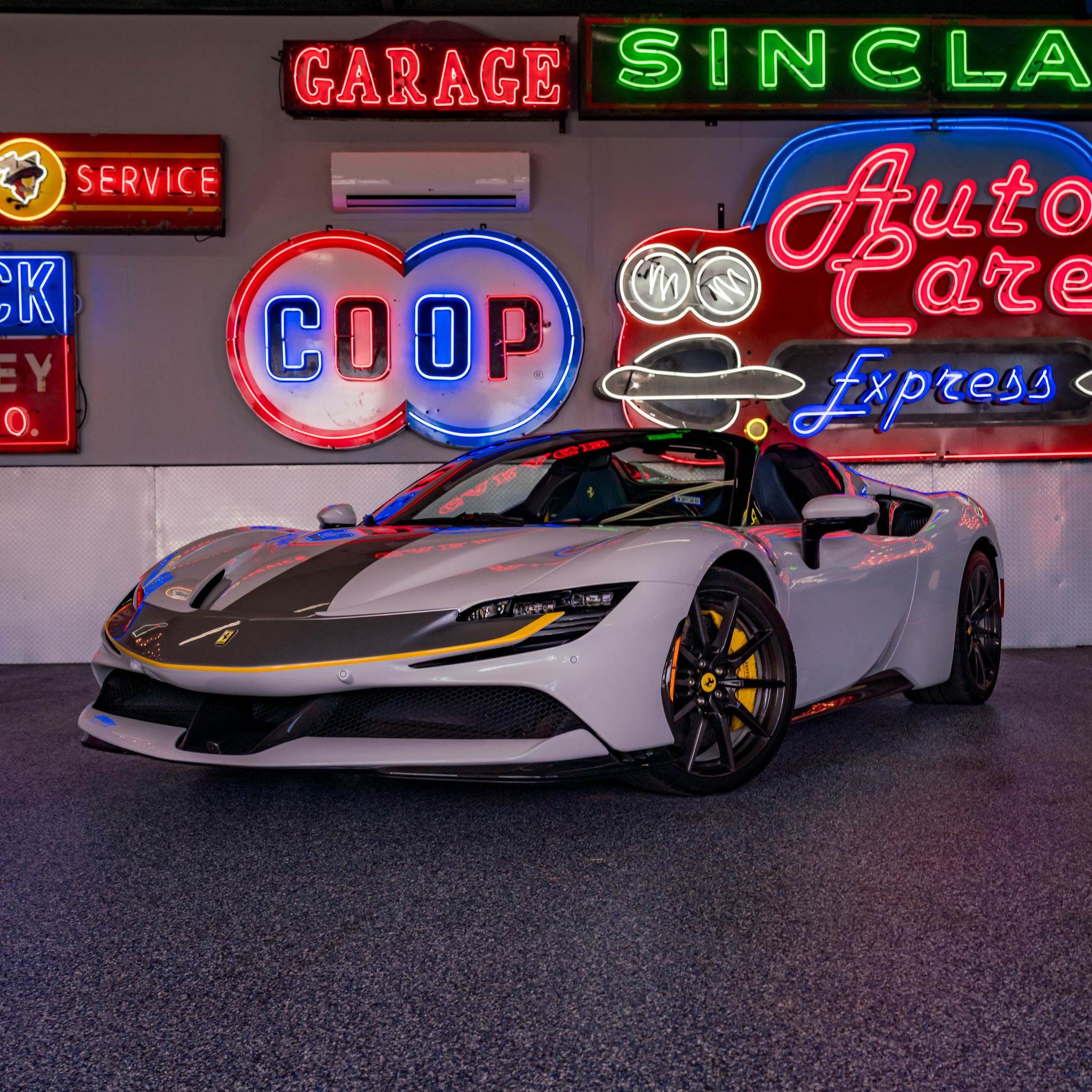 Vintage neon signs and a luxury Ferrari sports car, representing the Double E Lifestyle event