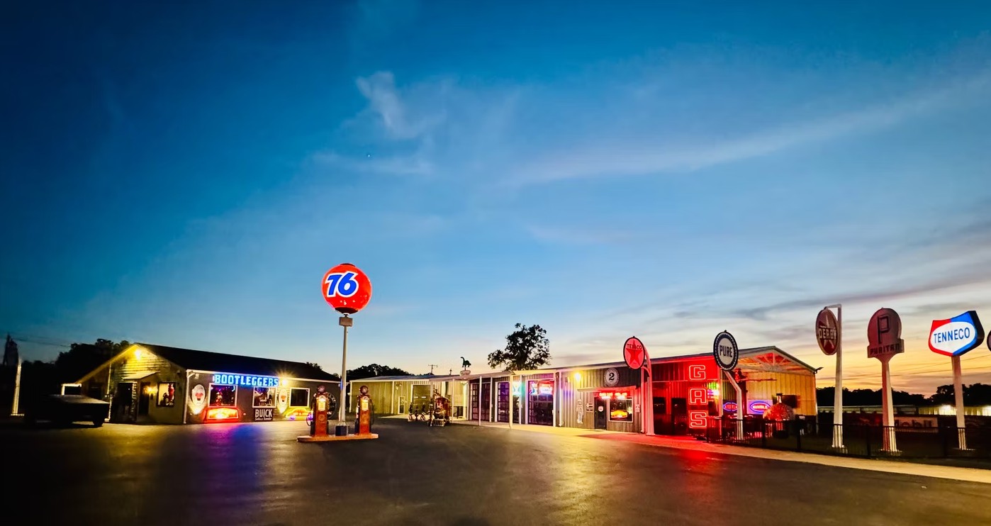 Double E Ranch & Venue exterior at dusk, vintage gas signs and illuminated building, Weatherford