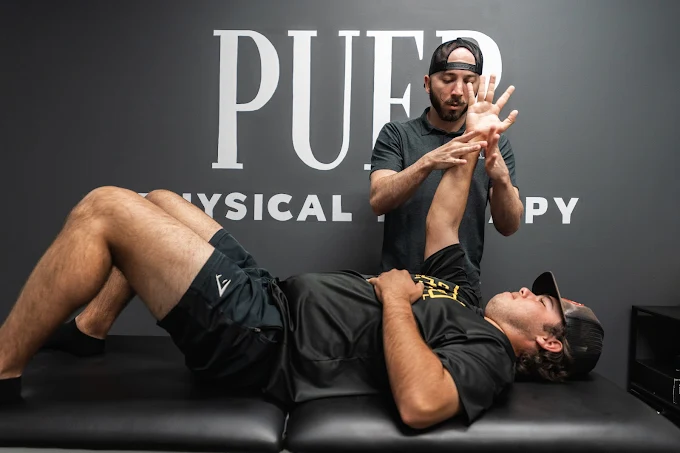 Patient working with a physical therapist during a one-on-one orthopedic evaluation Patient working with a physical therapist during a one-on-one orthopedic evaluation