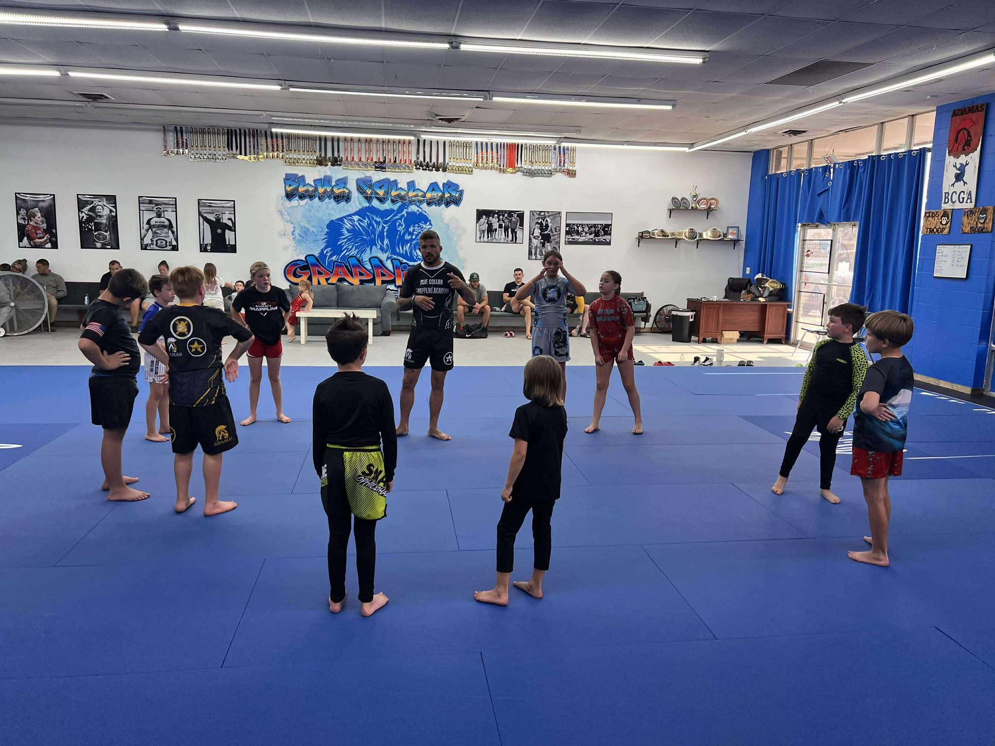 Kids Brazilian Jiu-Jitsu class training on the mats at Blue Collar Grappling Academy