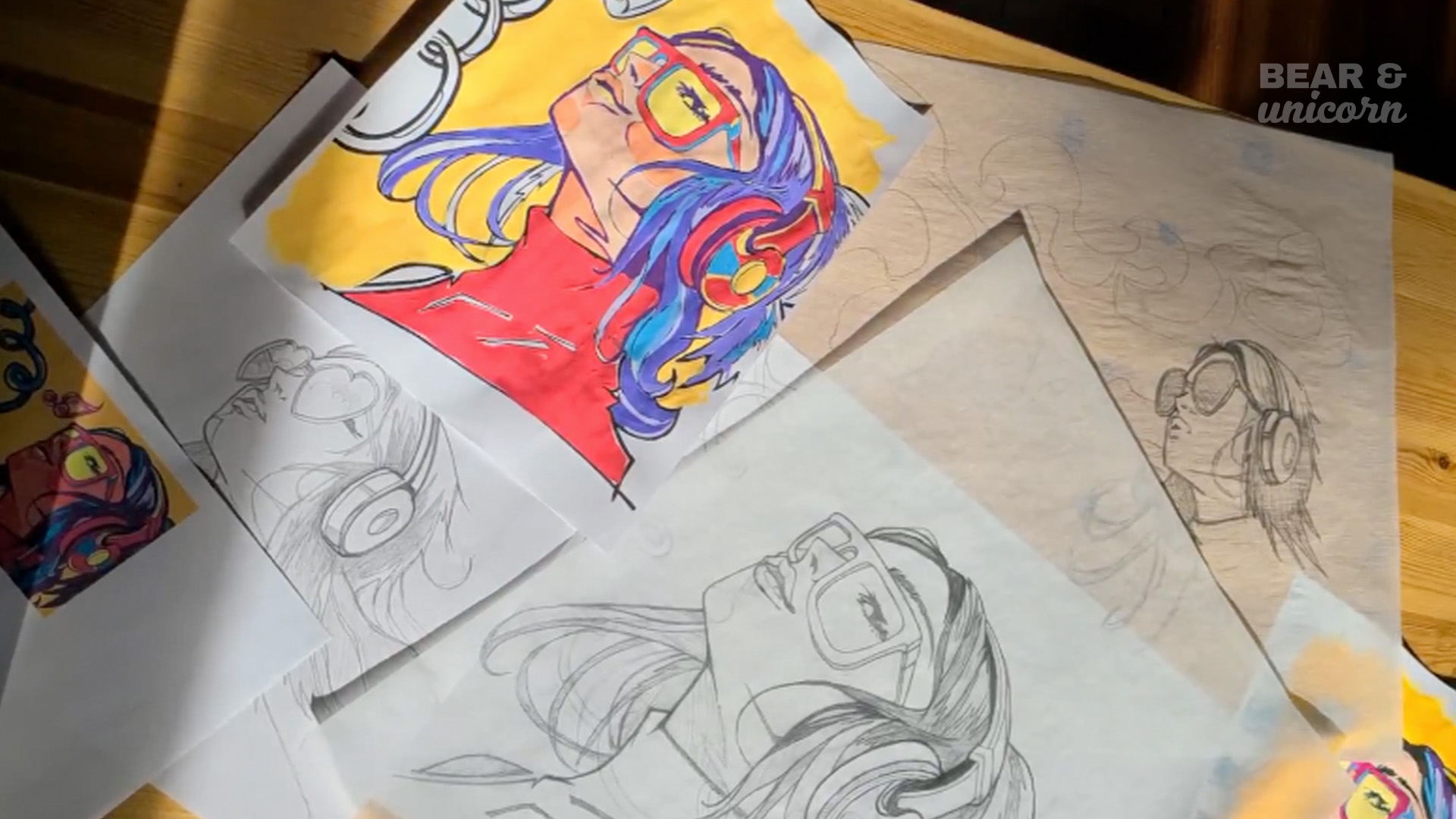 Artist sketches and a small colorful painting of the mural concept laid out on a table, showing the planning phase. Artist sketches and a small colorful painting of the mural concept laid out on a table, showing the planning phase.