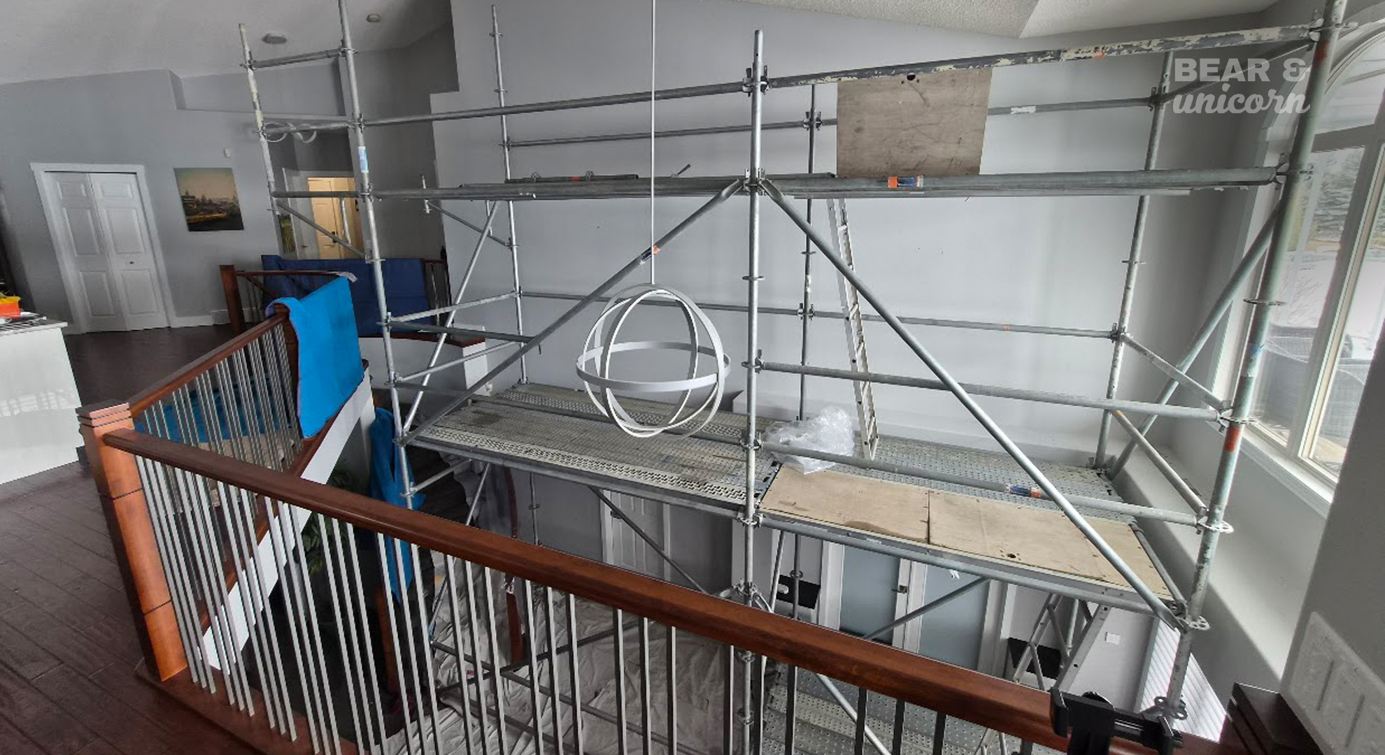 Industrial scaffolding built over a curved residential staircase to provide a safe 20-foot high painting platform. Industrial scaffolding built over a curved residential staircase to provide a safe 20-foot high painting platform.