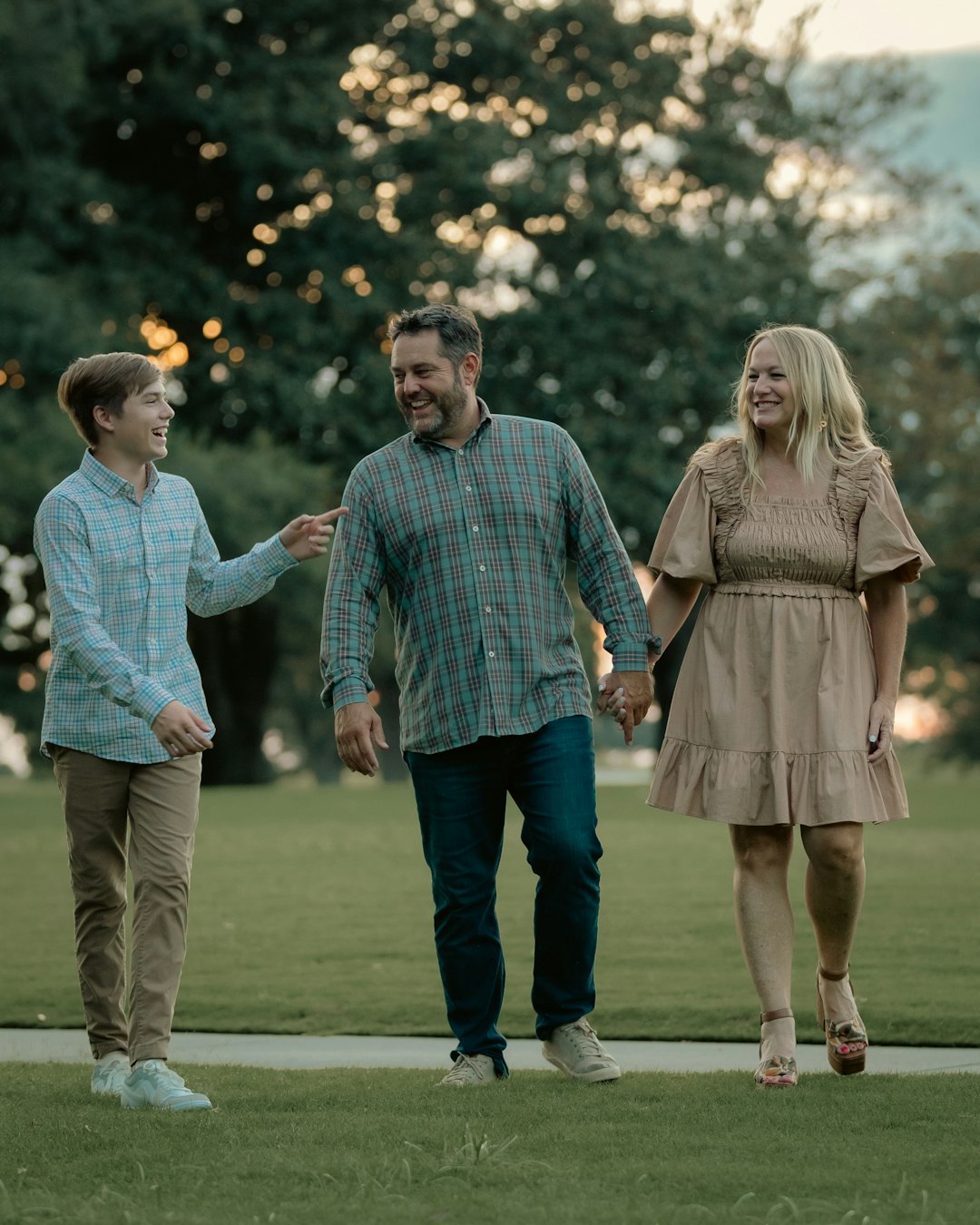family smiling at the park