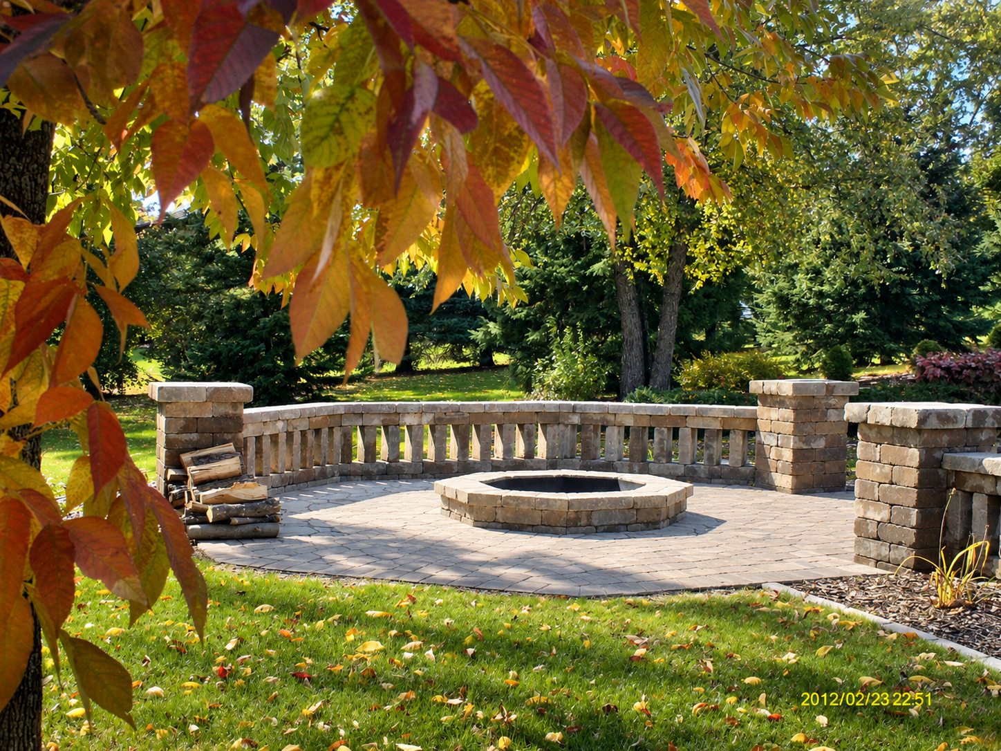 Paver patio, firepit, retaining wall, and lawn by MasterPlan Landscapes, LLC