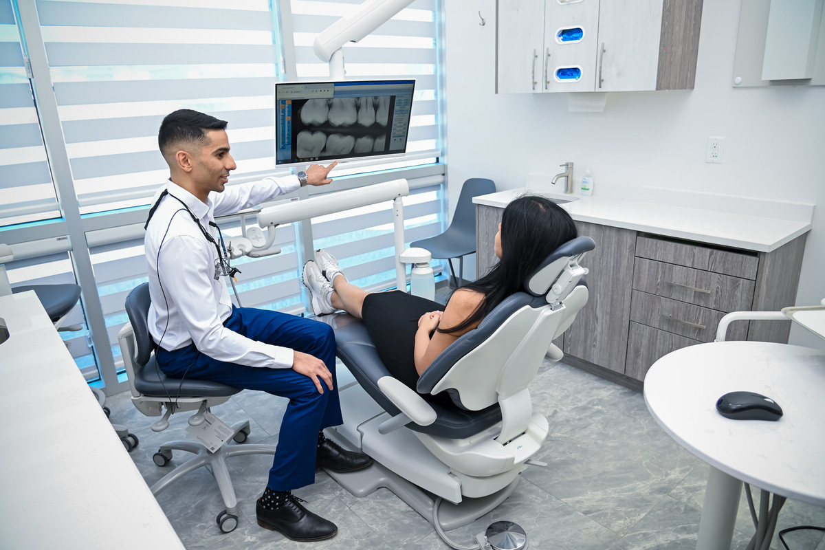 A dentist at One Dental reviewing a patient's scans with them chairside