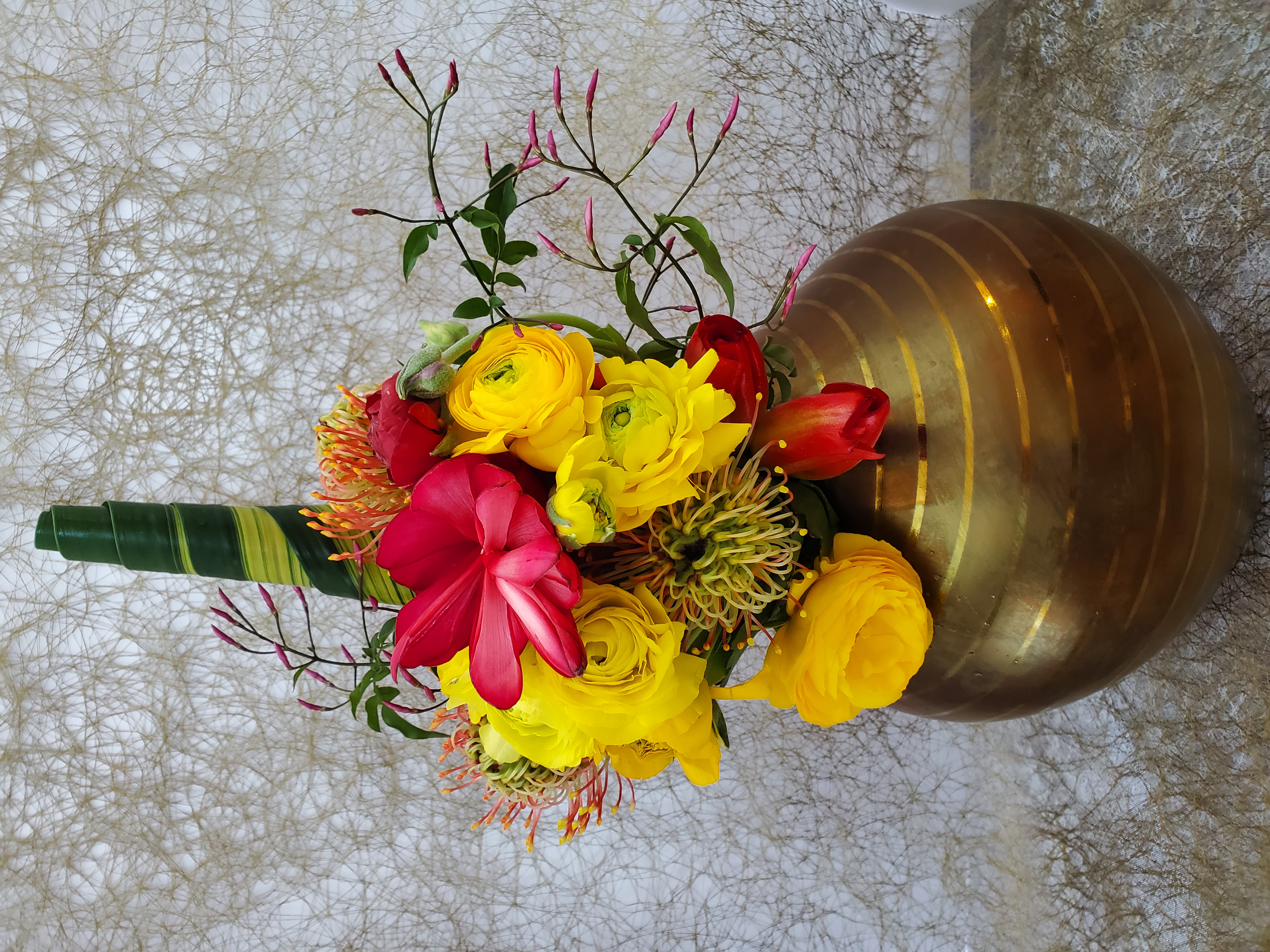 Orange rose floral arrangement with green and white flowers by Rikka Floral