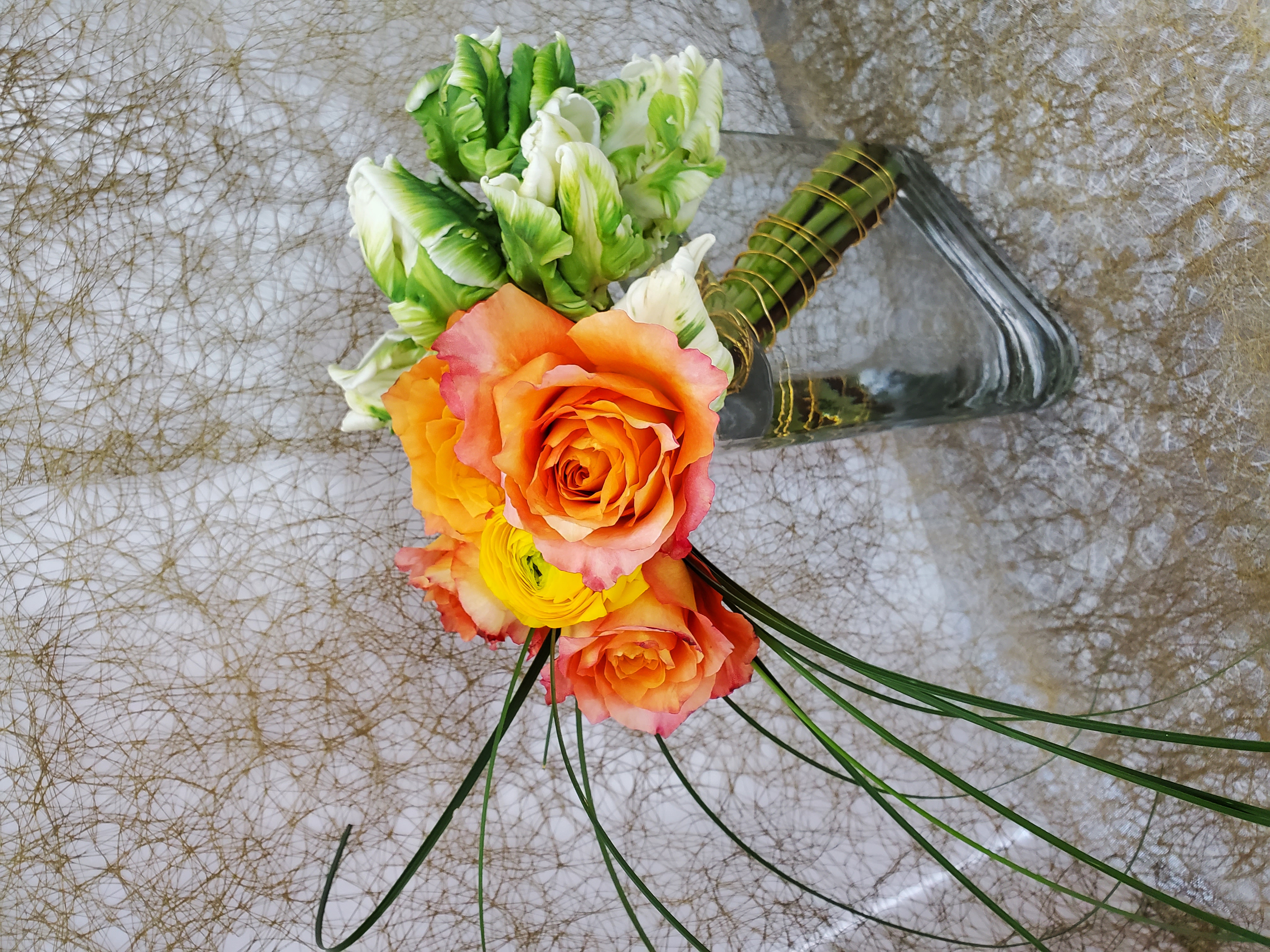 Tropical heliconia floral arrangement with yellow and orange flowers by Rikka Floral