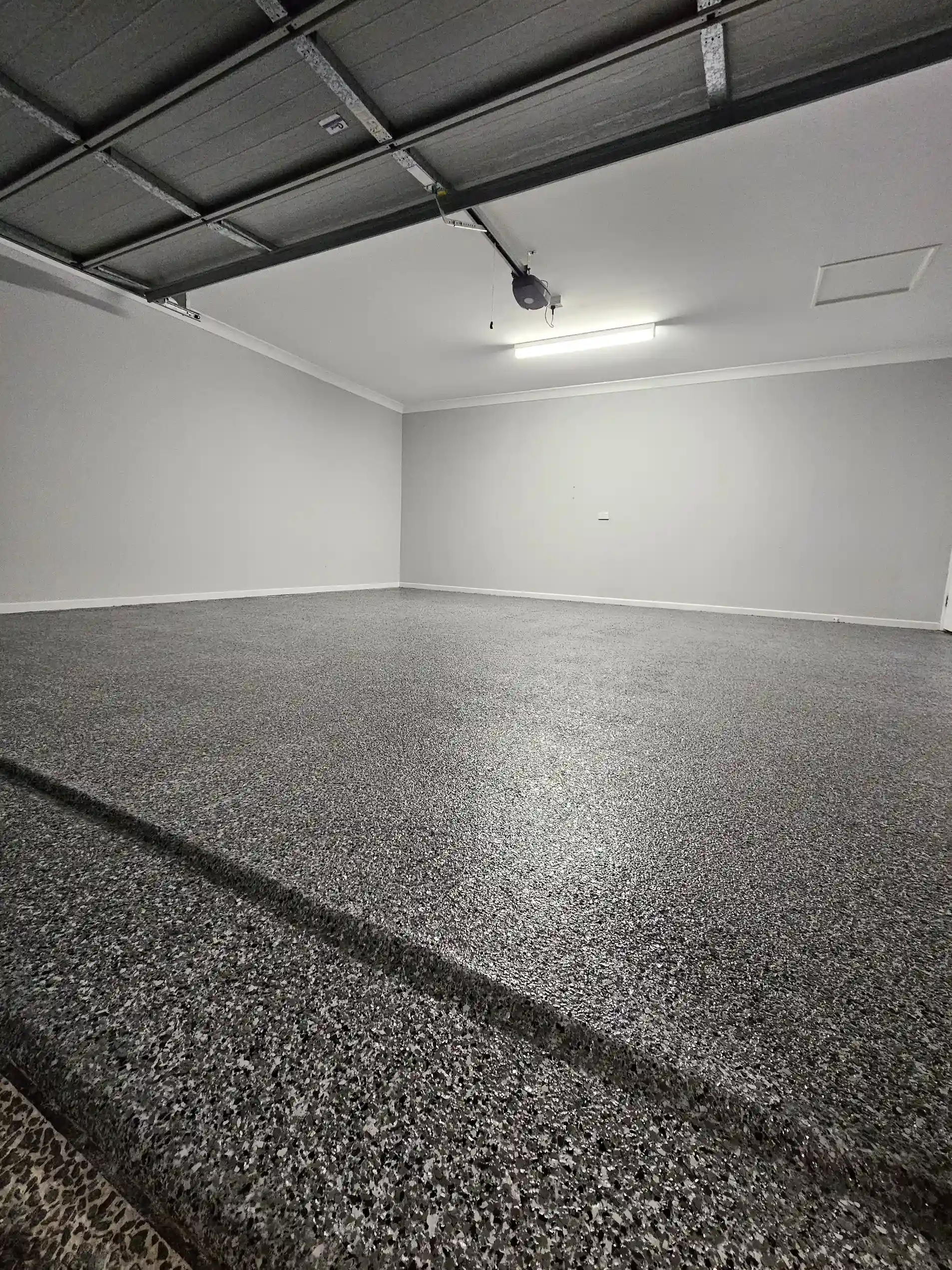 Epoxy garage floor coating in Maroochydore by Best Coat Epoxy showing a durable decorative flake finish