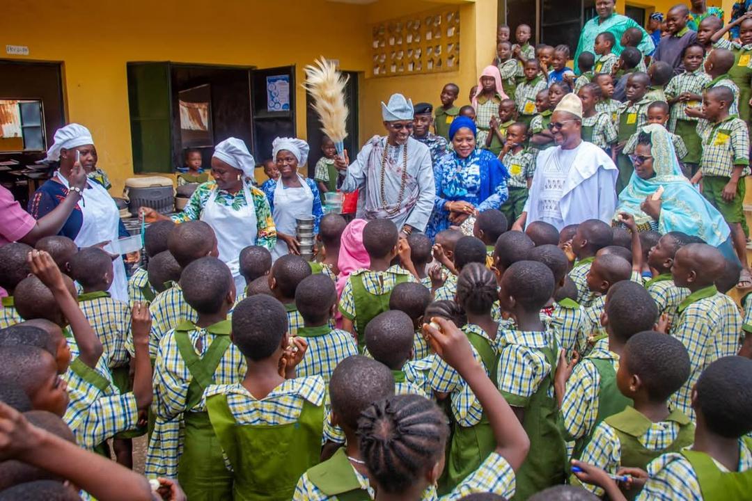 Olowu of Owu feeding the children, CeSAHA School Health Project SHP