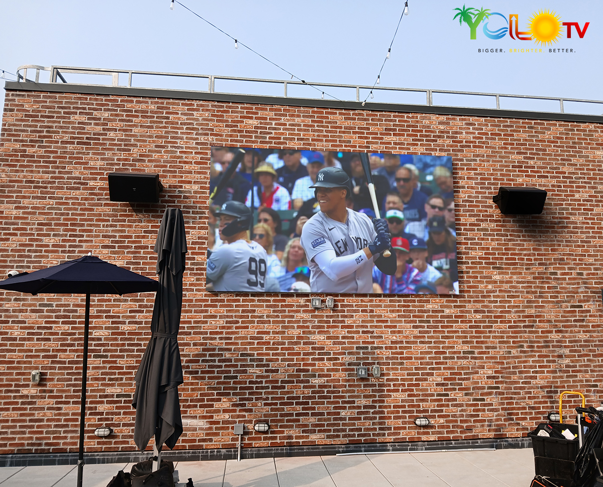 158-inch YOLO TV wall-mounted outdoors, staying bright and readable in direct sunlight