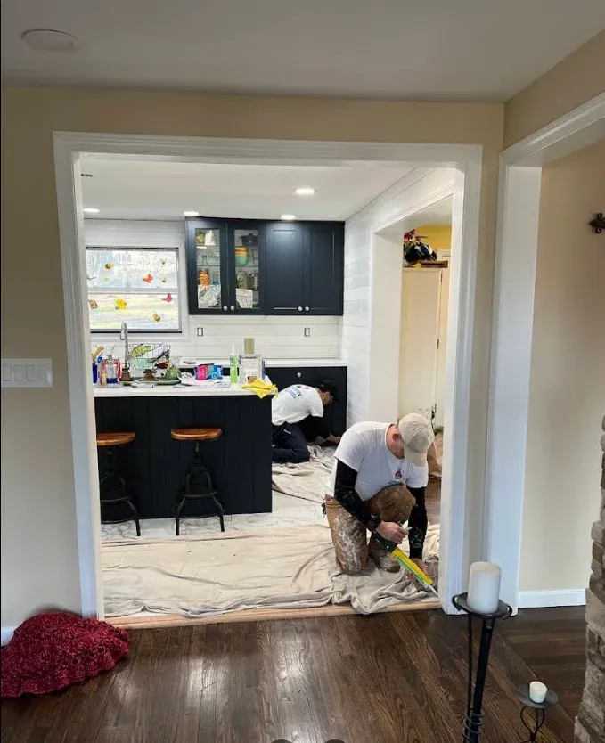 Painter working on doorway trim
