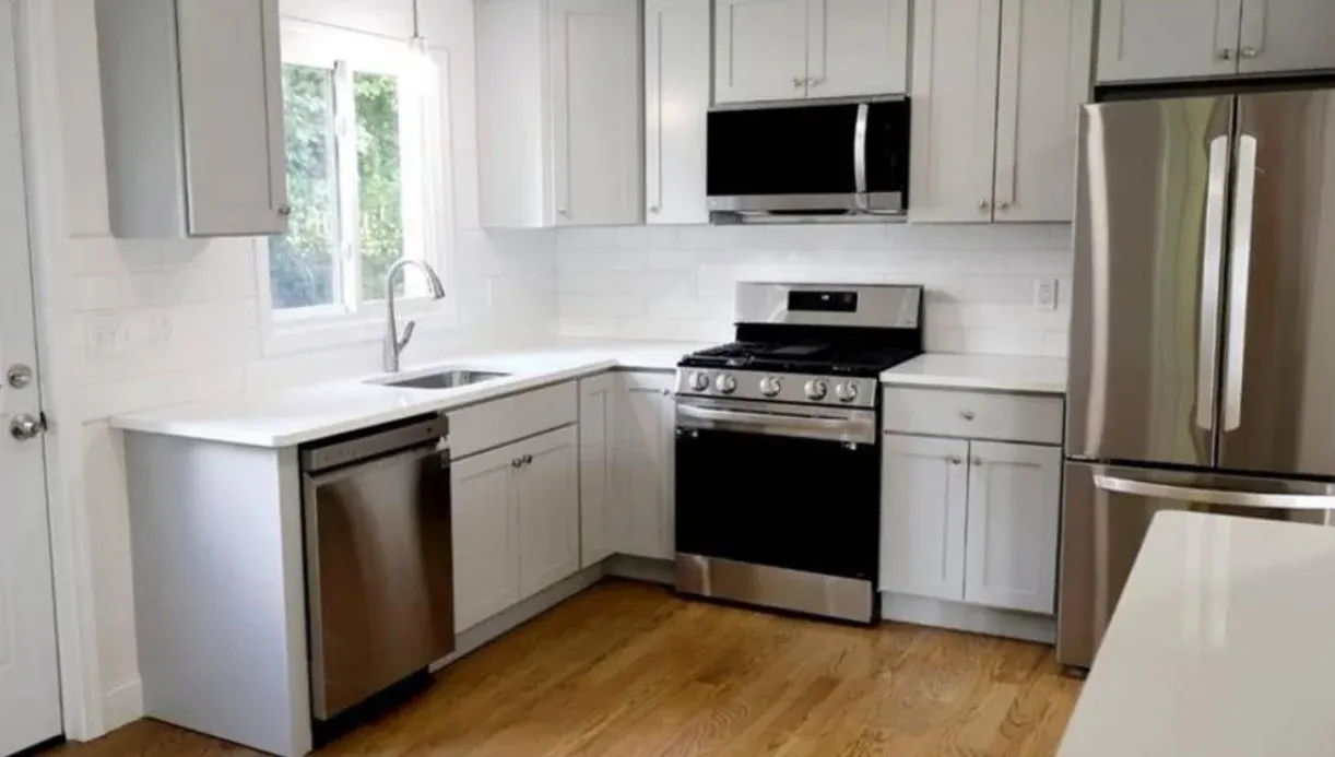 Refinished white kitchen cabinets with stainless appliances