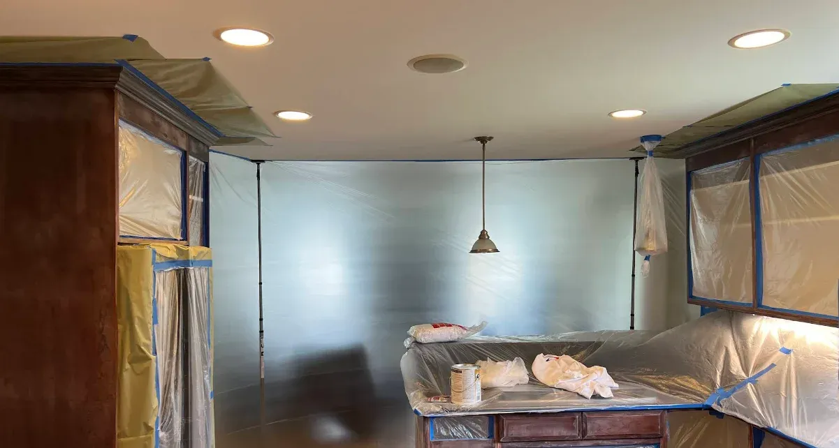 Kitchen cabinets masked for spraying