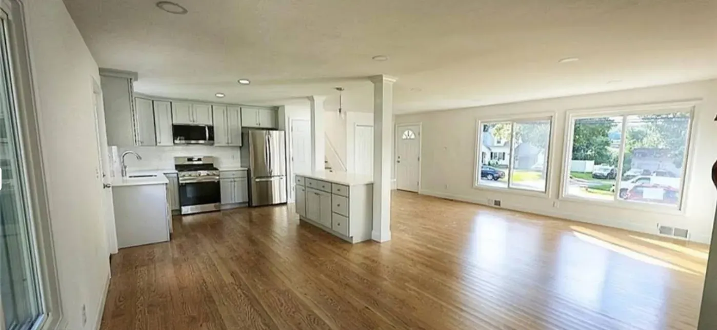Refinished white kitchen cabinets with stainless appliances