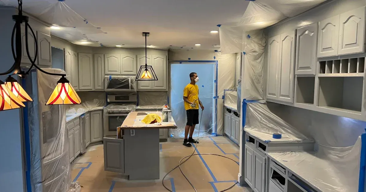 Kitchen cabinet refinishing, masked and prepped for spraying