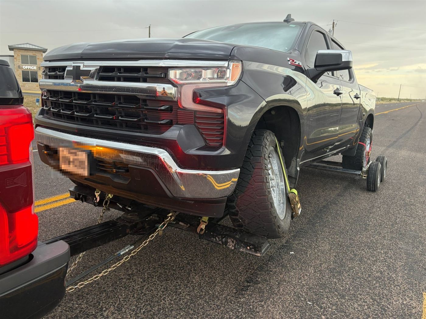 Truck secured with chain and straps