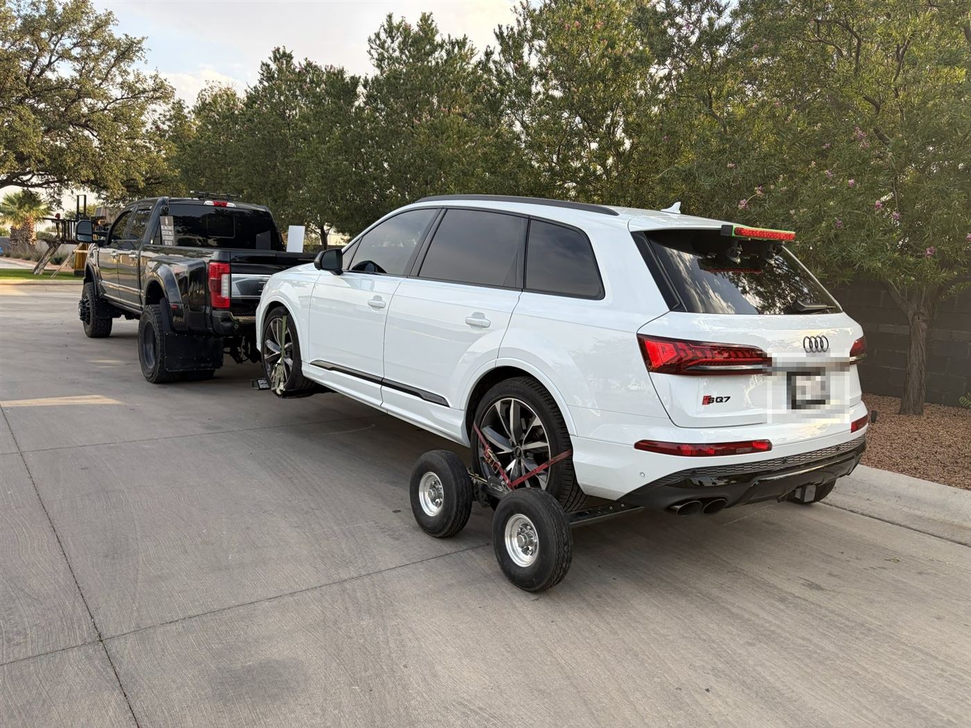 White Audi SUV on tow dollies