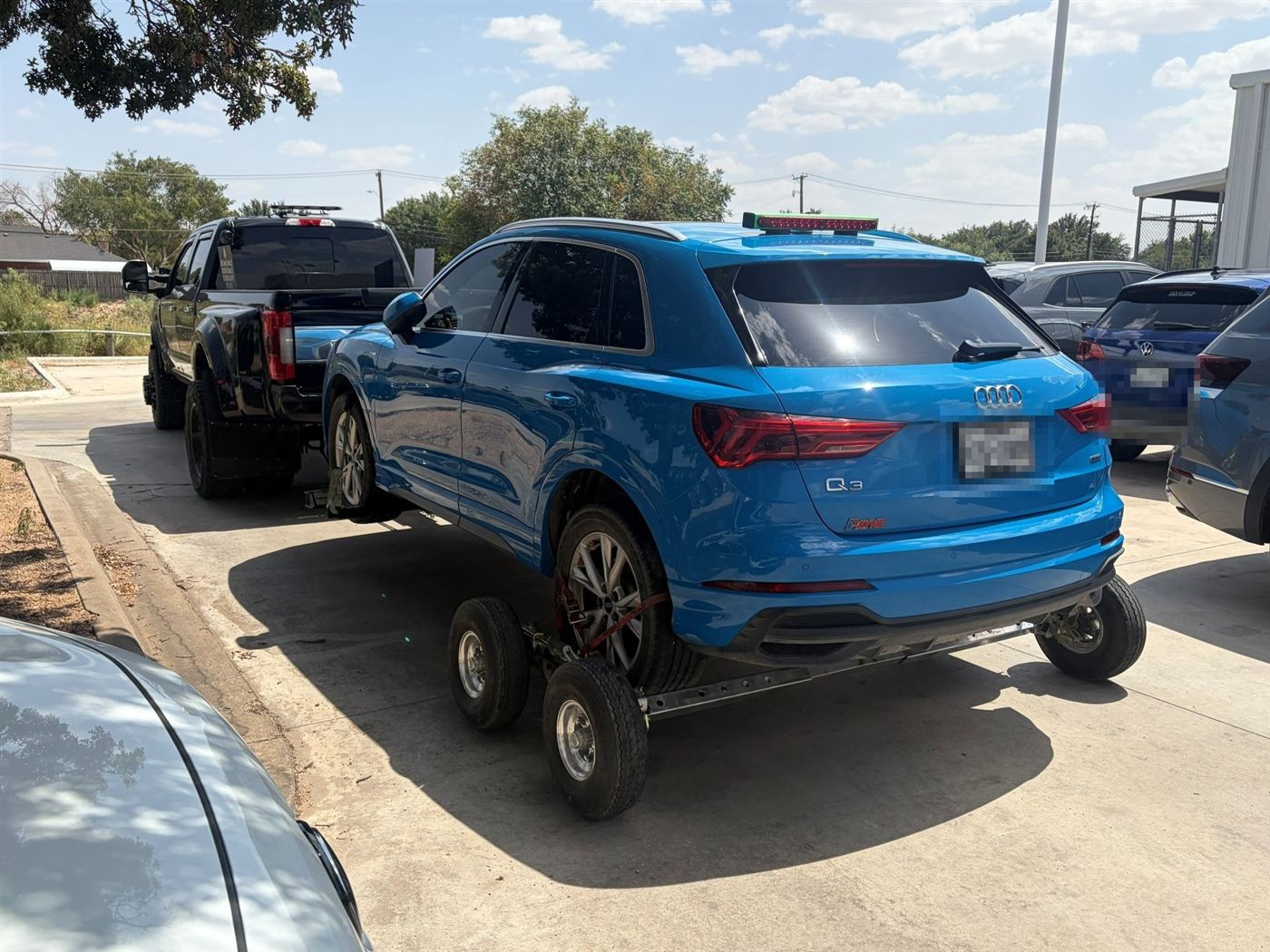 Blue Audi Q3 on tow dollies