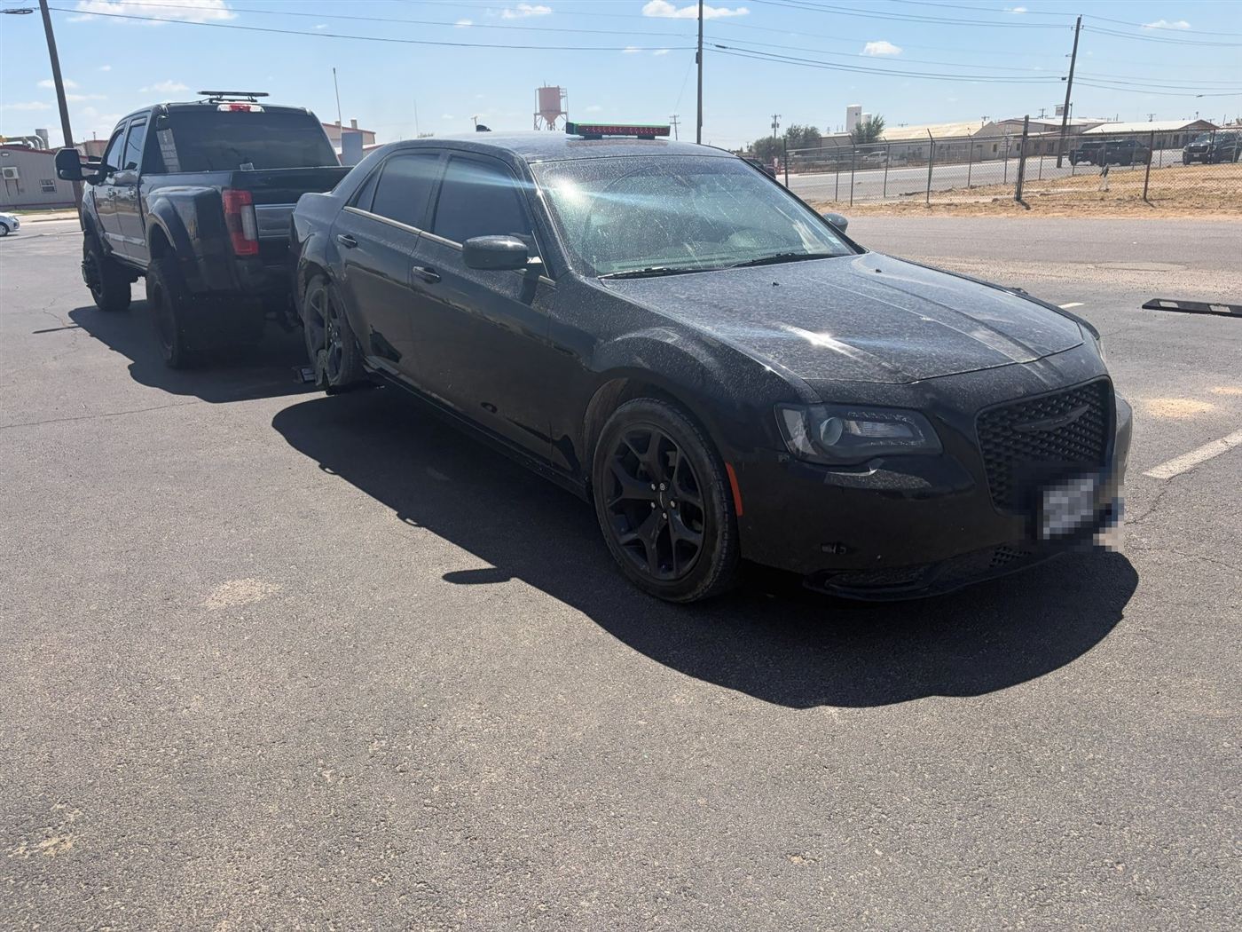Black Chrysler 300 being towed