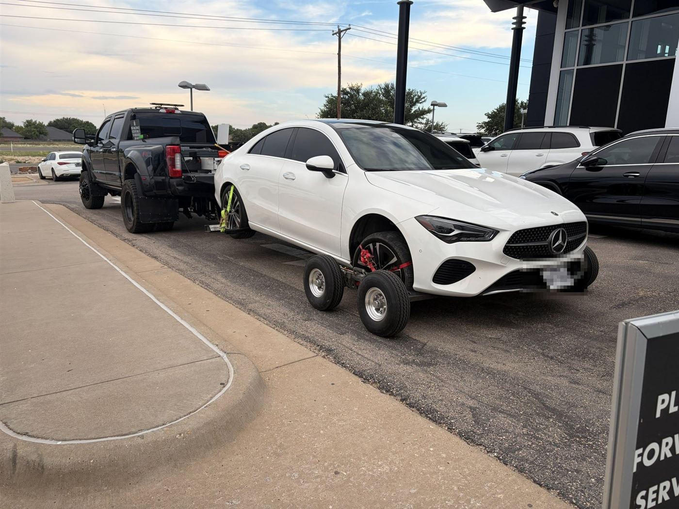 White Mercedes CLA on tow dollies