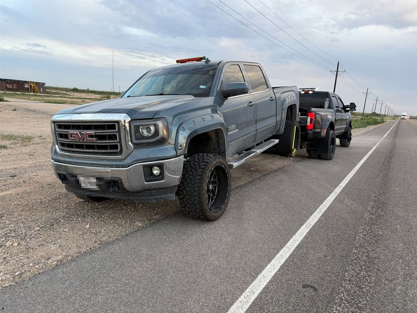 GMC pickup being towed