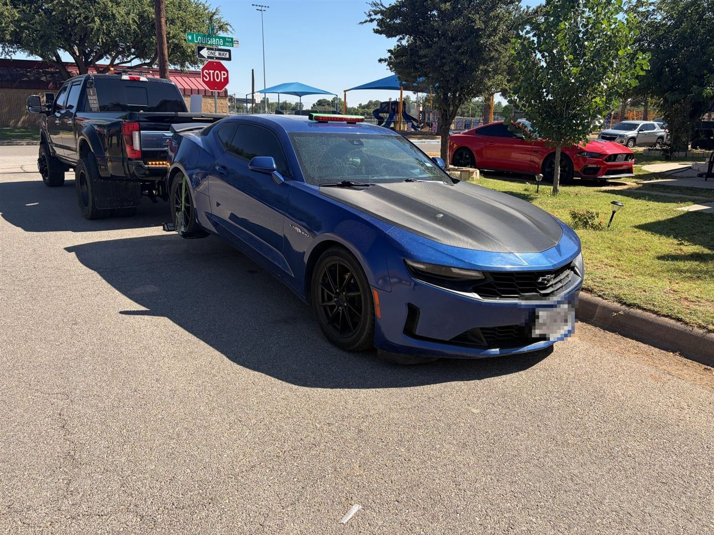 Blue Chevrolet Camaro being towed
