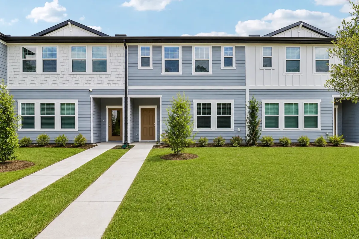 Malin townhomes by Starlight Homes at Pelham Square in DeLand, FL, a row of two-story townhomes with front walks