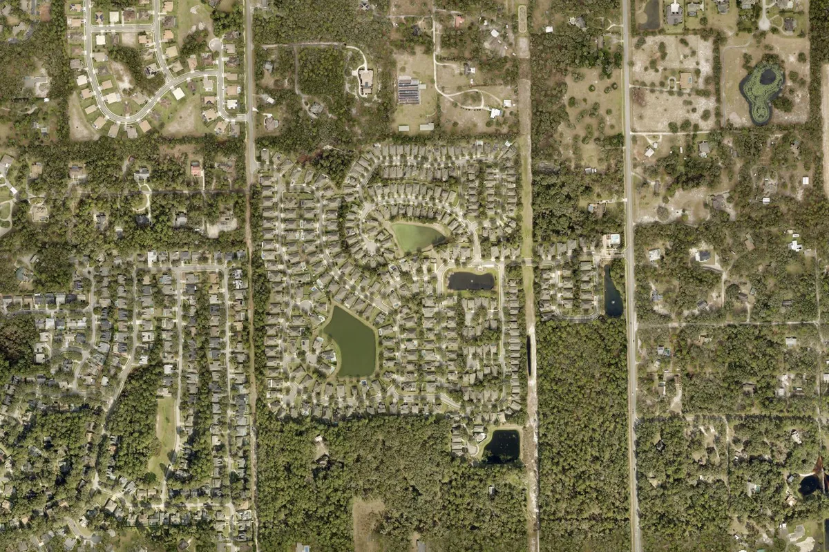 2024 Volusia County aerial photo of the Saddlebrook neighborhood in southeast DeLand, FL, with curving streets around ponds