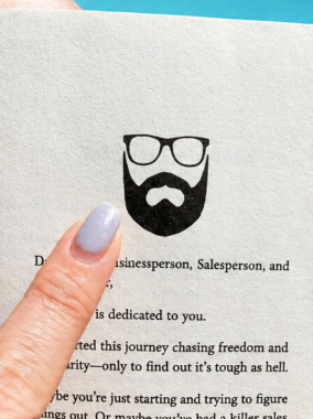 A reader holding the book Teach to Sell, which is dedicated to you